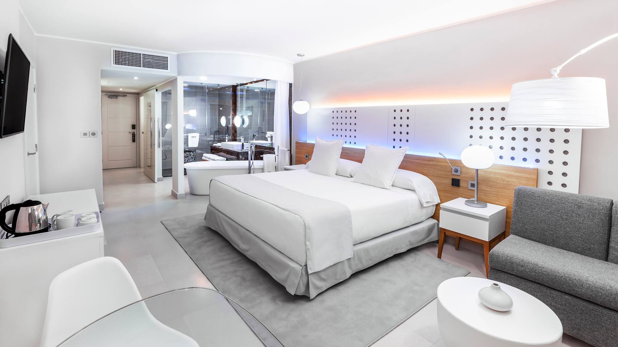 a bedroom with a bed and a tub