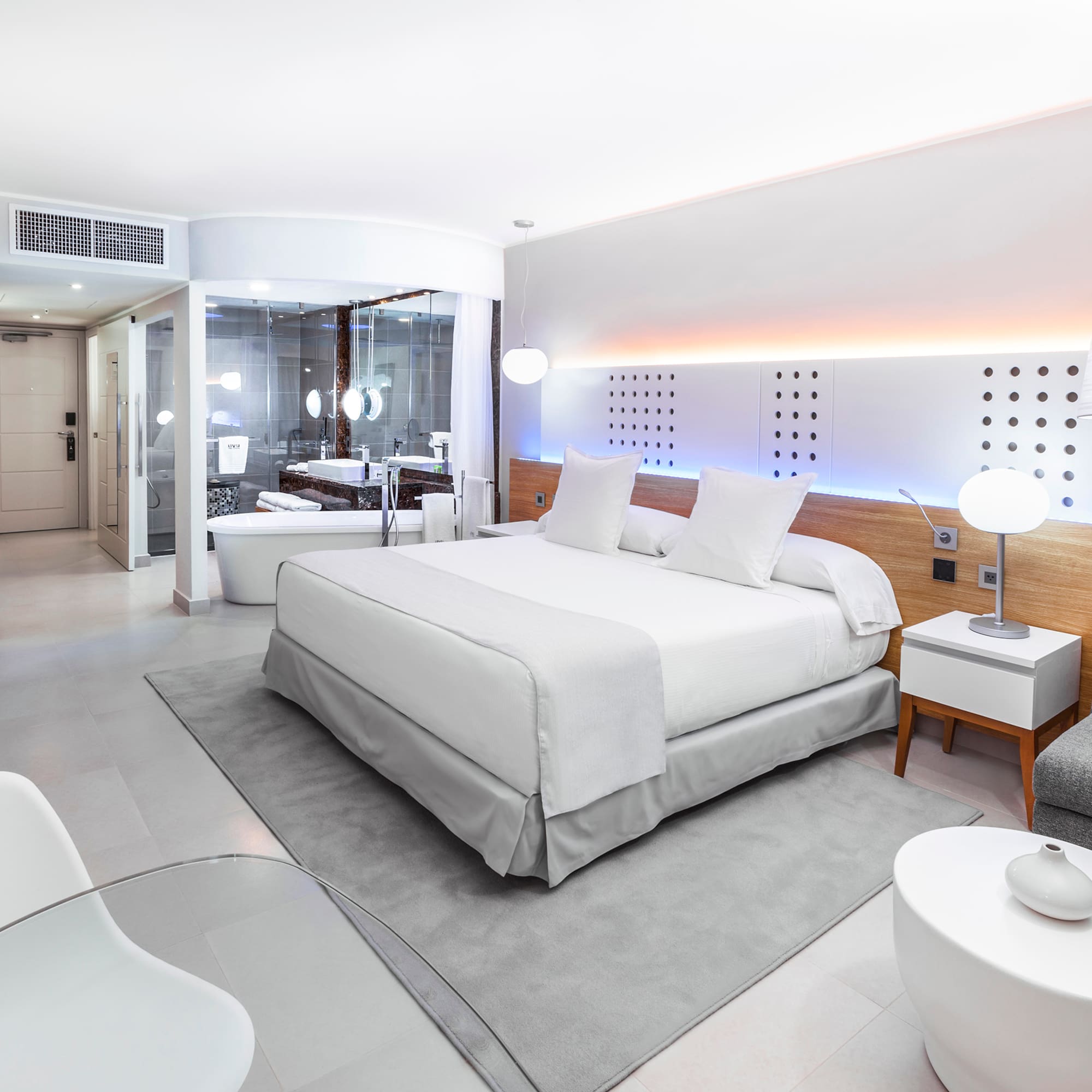 a bedroom with a bed and a tub