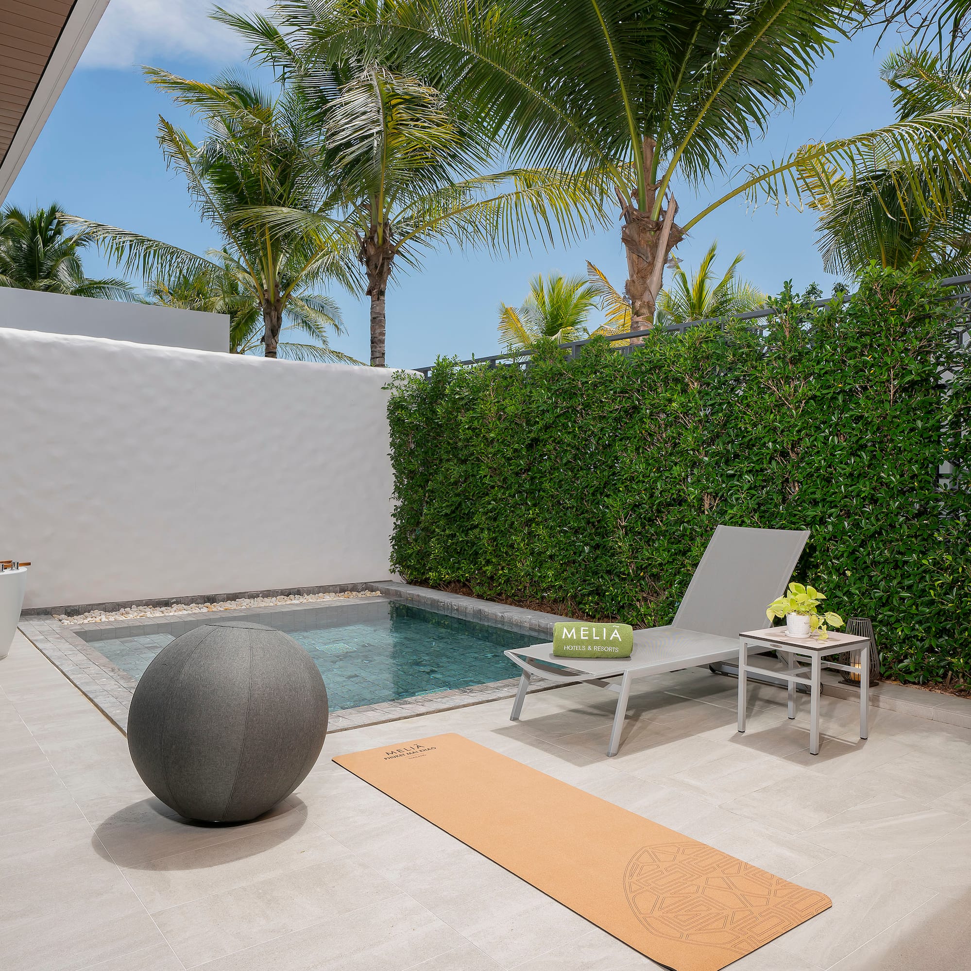 a pool and chair on a patio