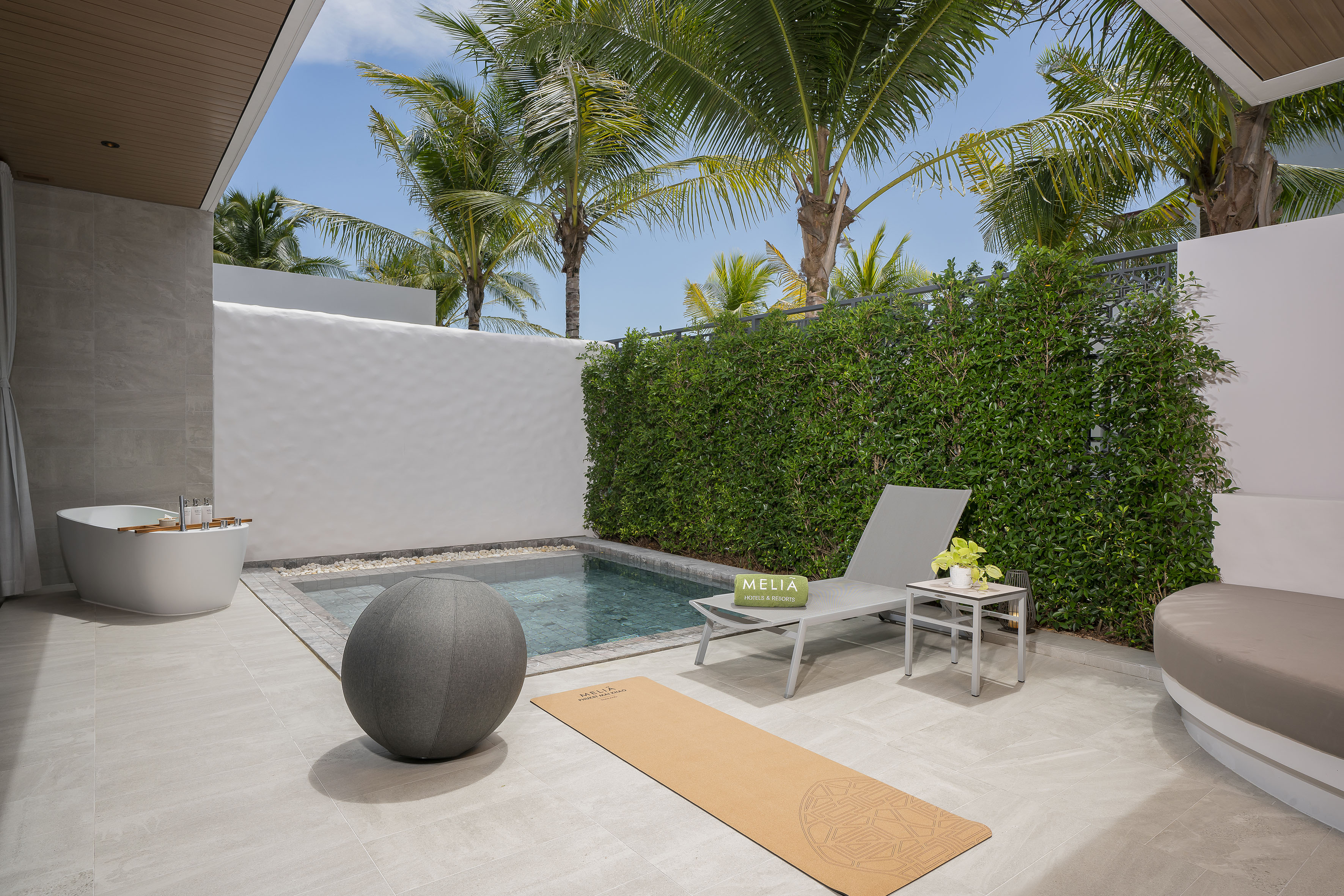 Melia resort patio with private plunge pool, outdoor bath, and yoga mat.
