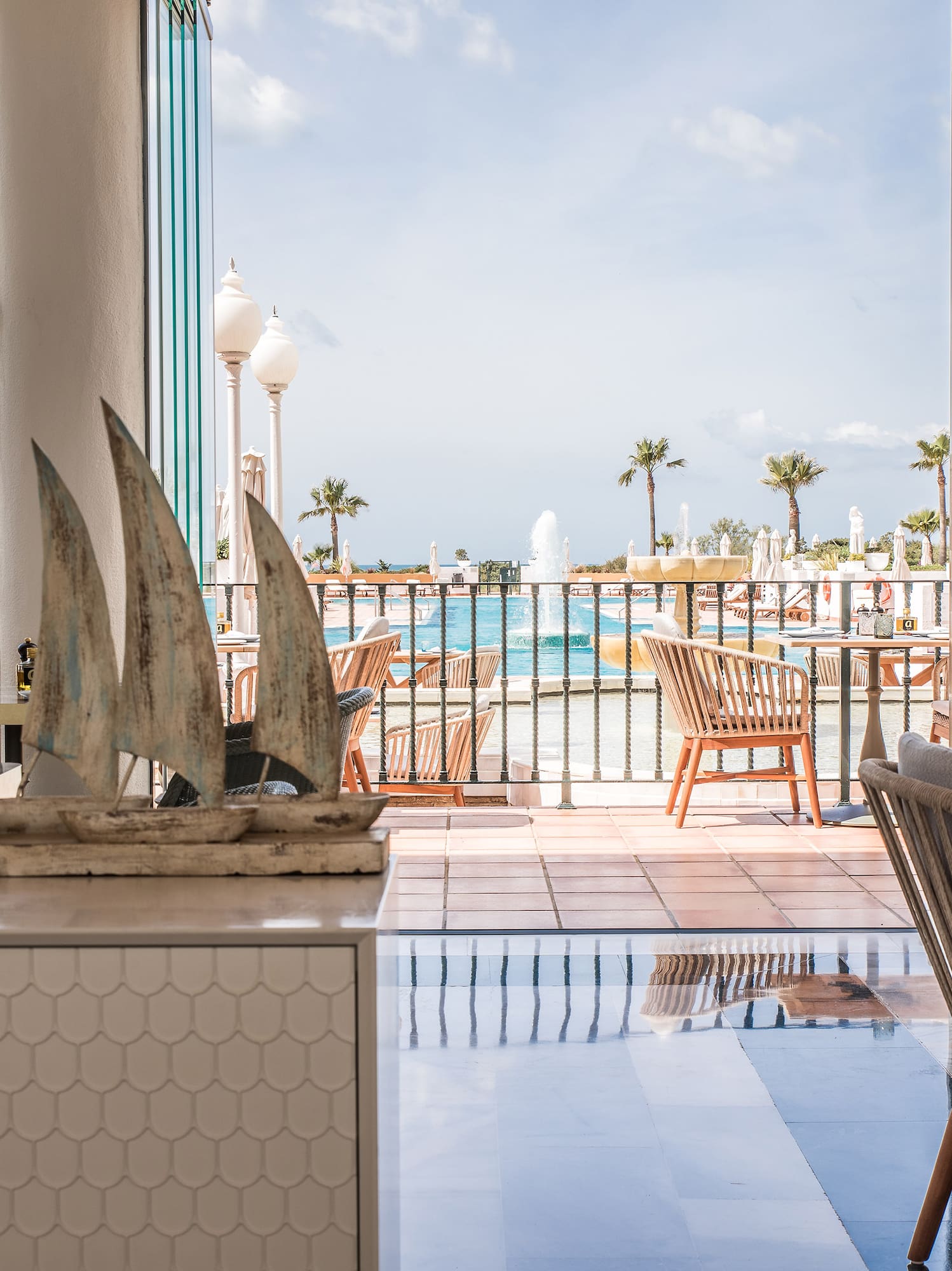 a room with a view of the ocean and a boat sculpture