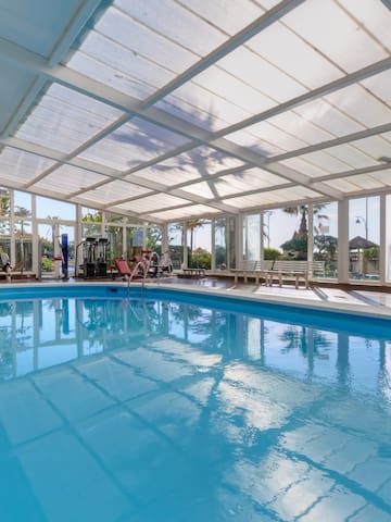 a swimming pool with a glass roof