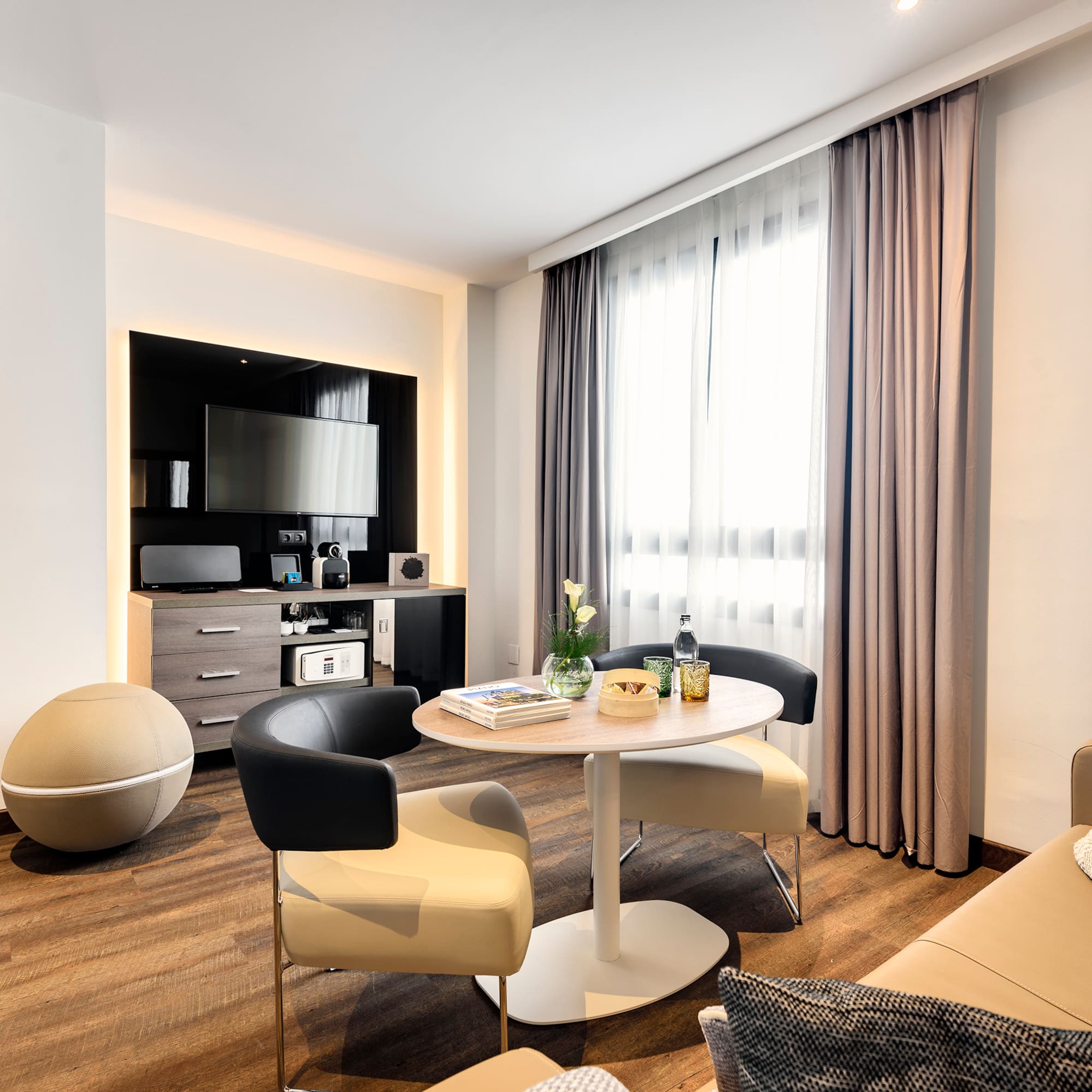 a room with a round table and chairs