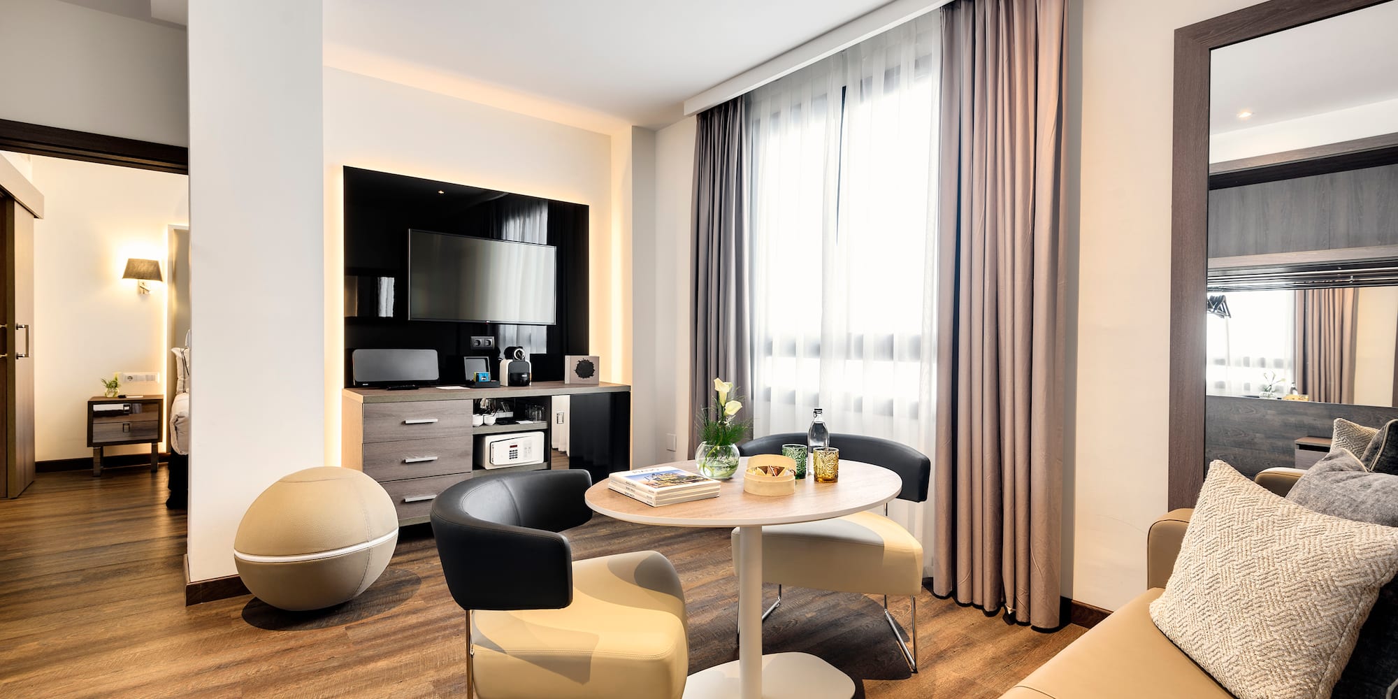 a room with a round table and chairs