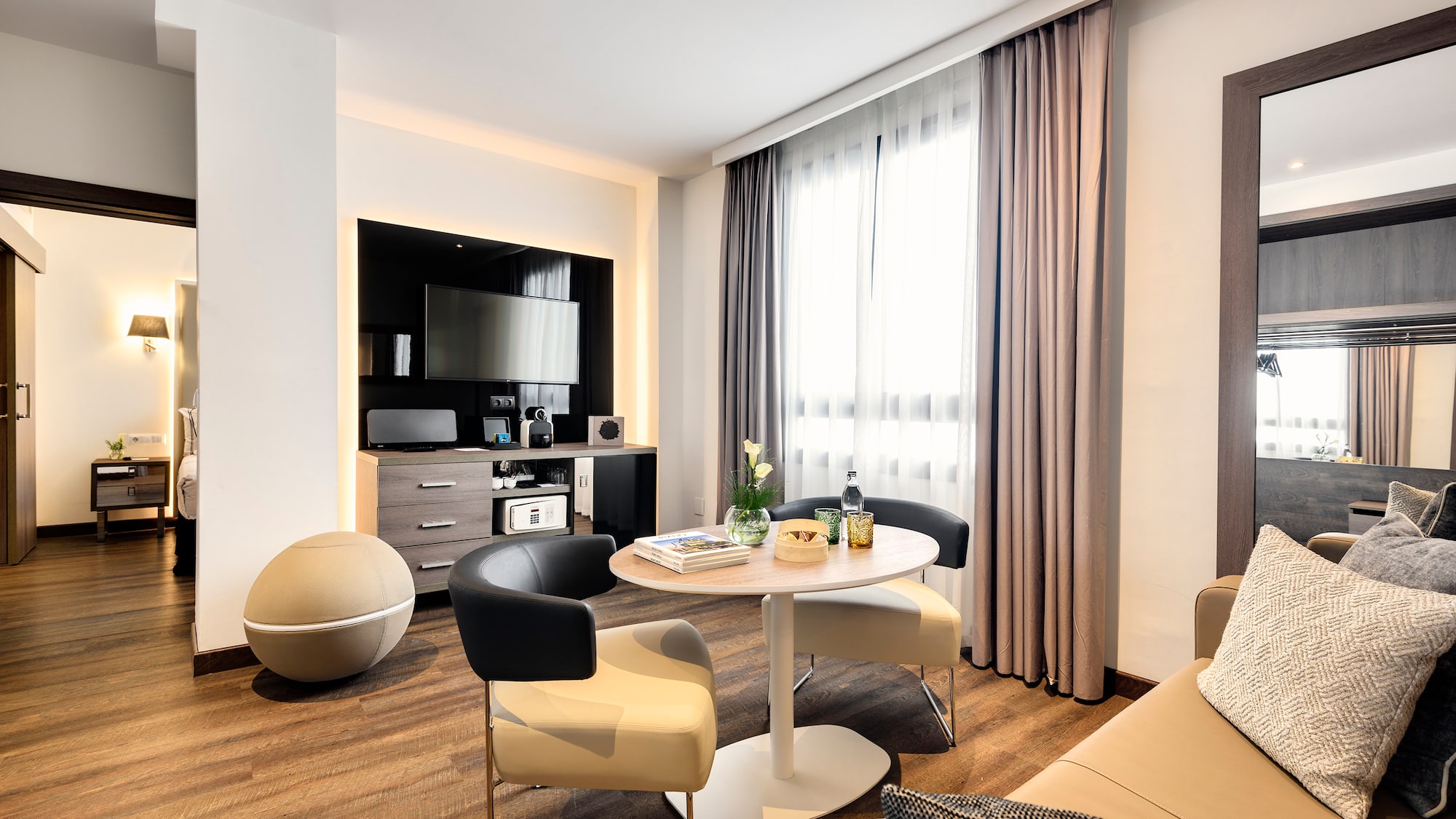 a room with a round table and chairs