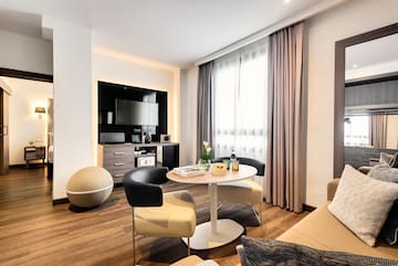 a room with a round table and chairs