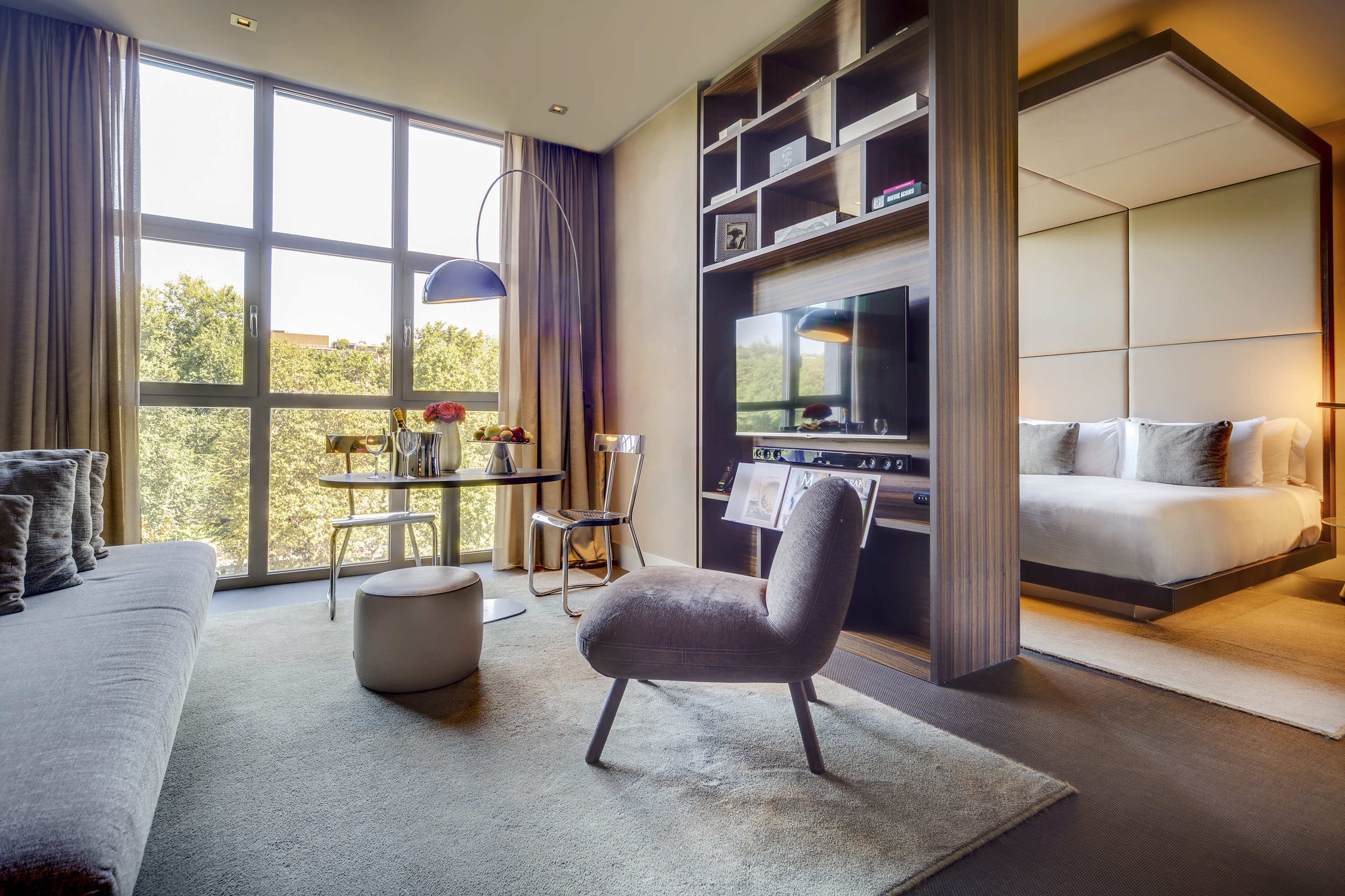 Contemporary hotel suite featuring living area, dining, and bedroom.