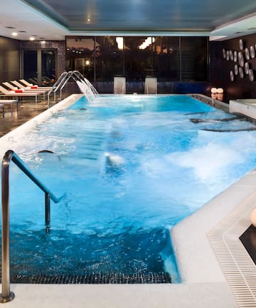 a large indoor pool with a jacuzzi