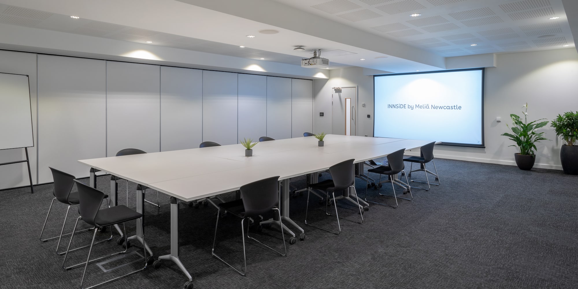 a large conference room with a projection screen