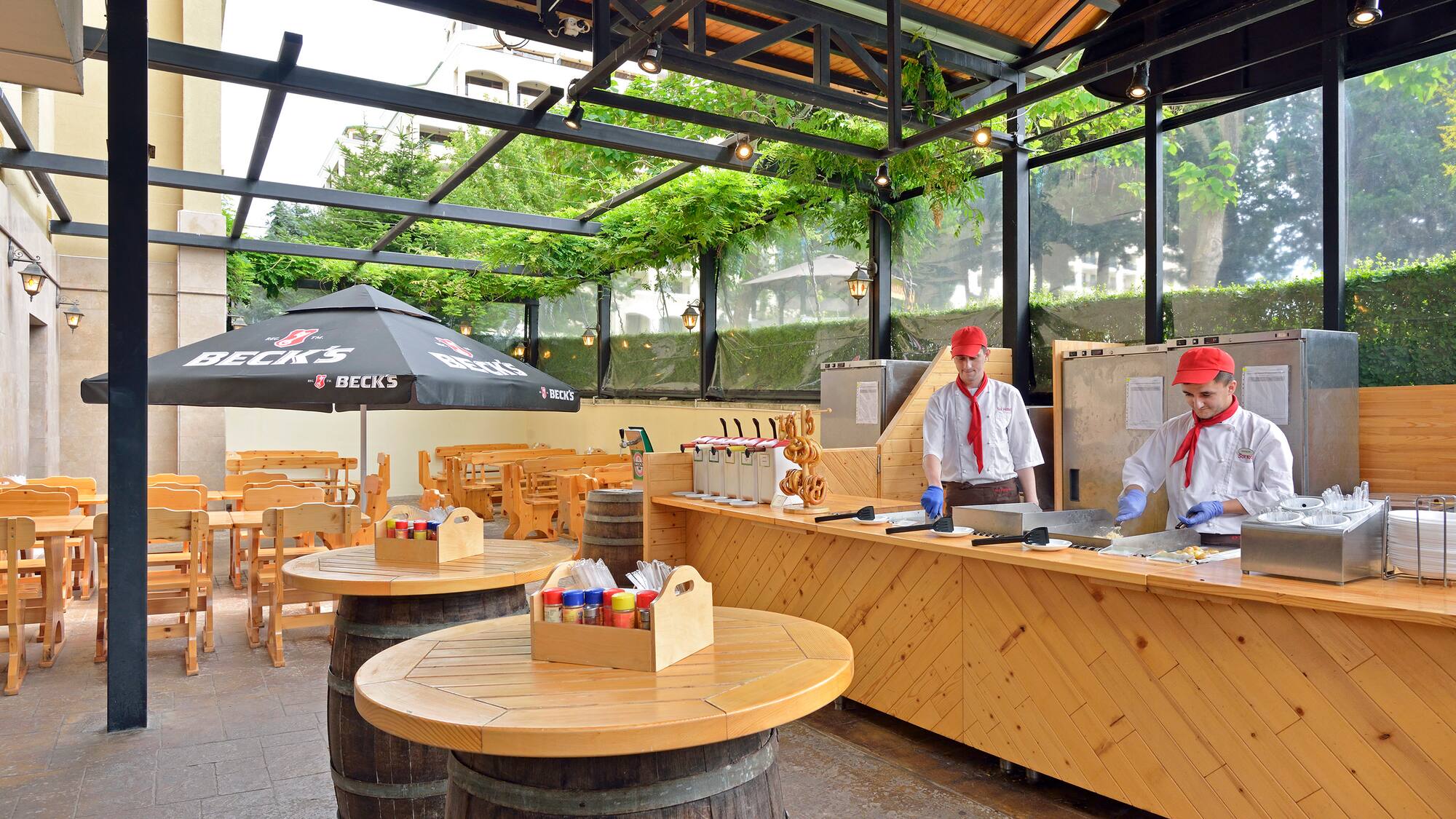a group of men in white uniforms standing at a counter in a restaurant