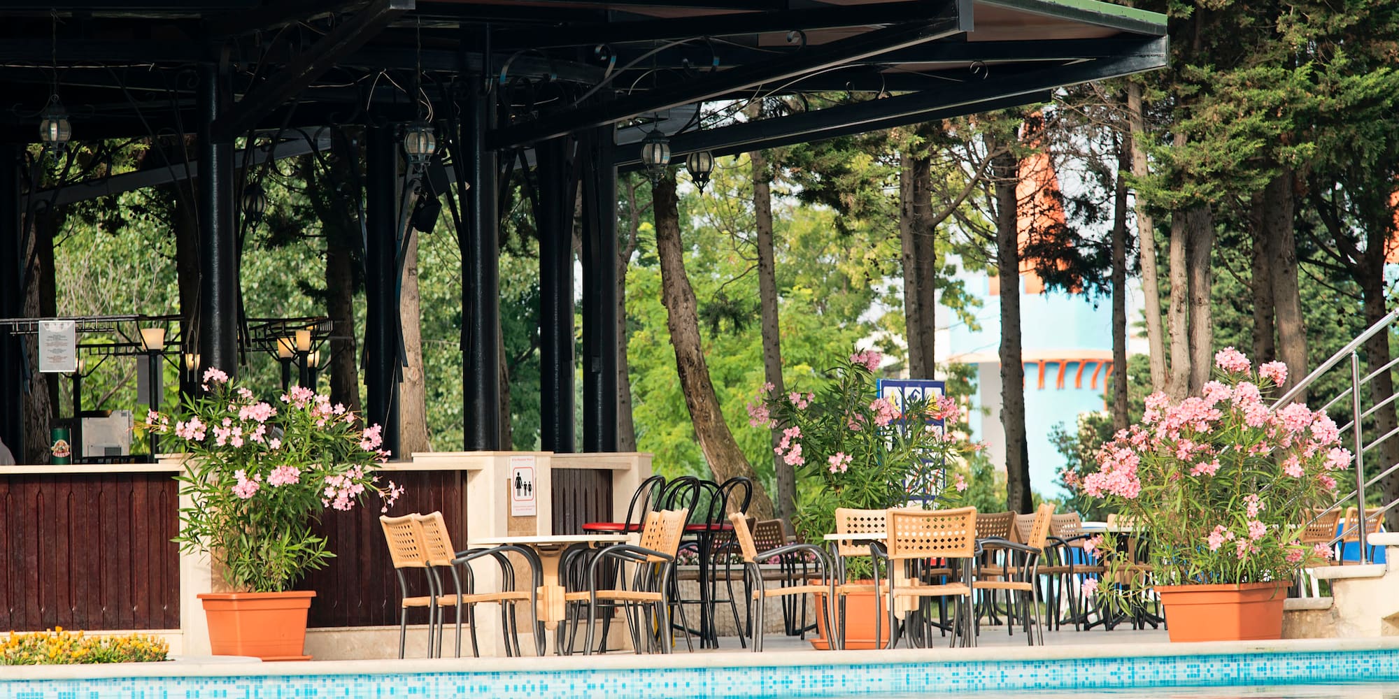 a pool with chairs and tables