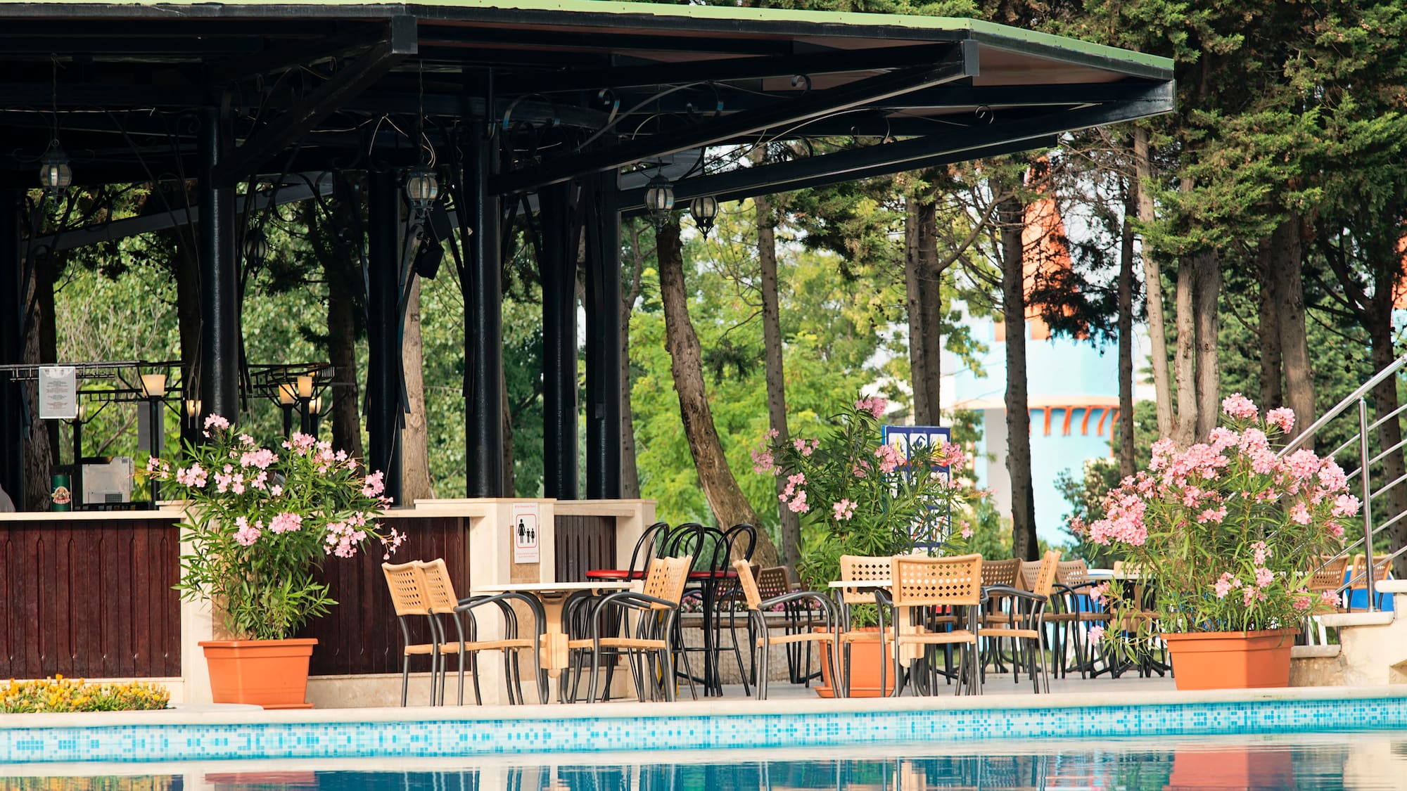 a pool with chairs and tables