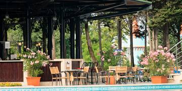 a pool with chairs and tables