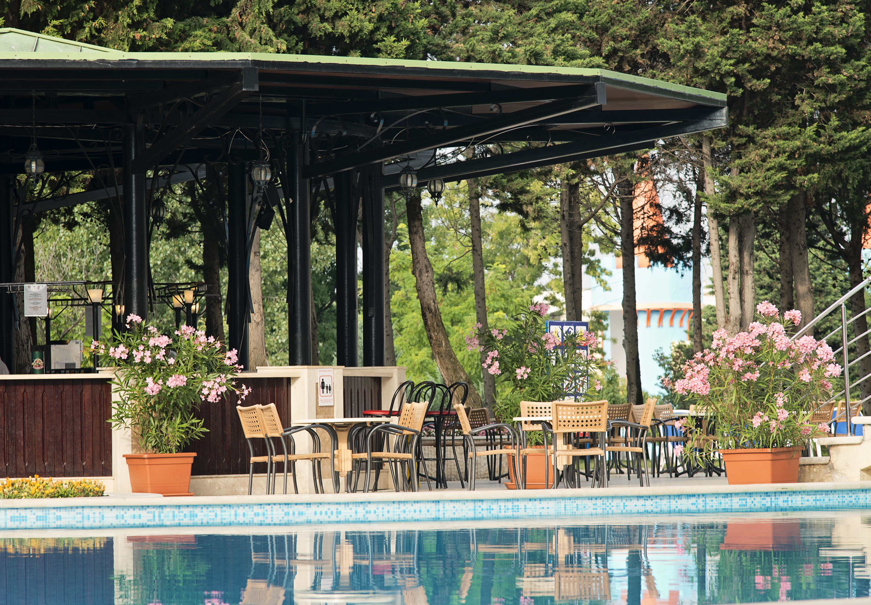 a pool with chairs and tables