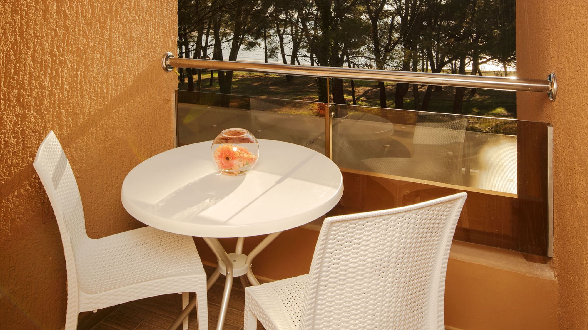 a table and chairs outside a window