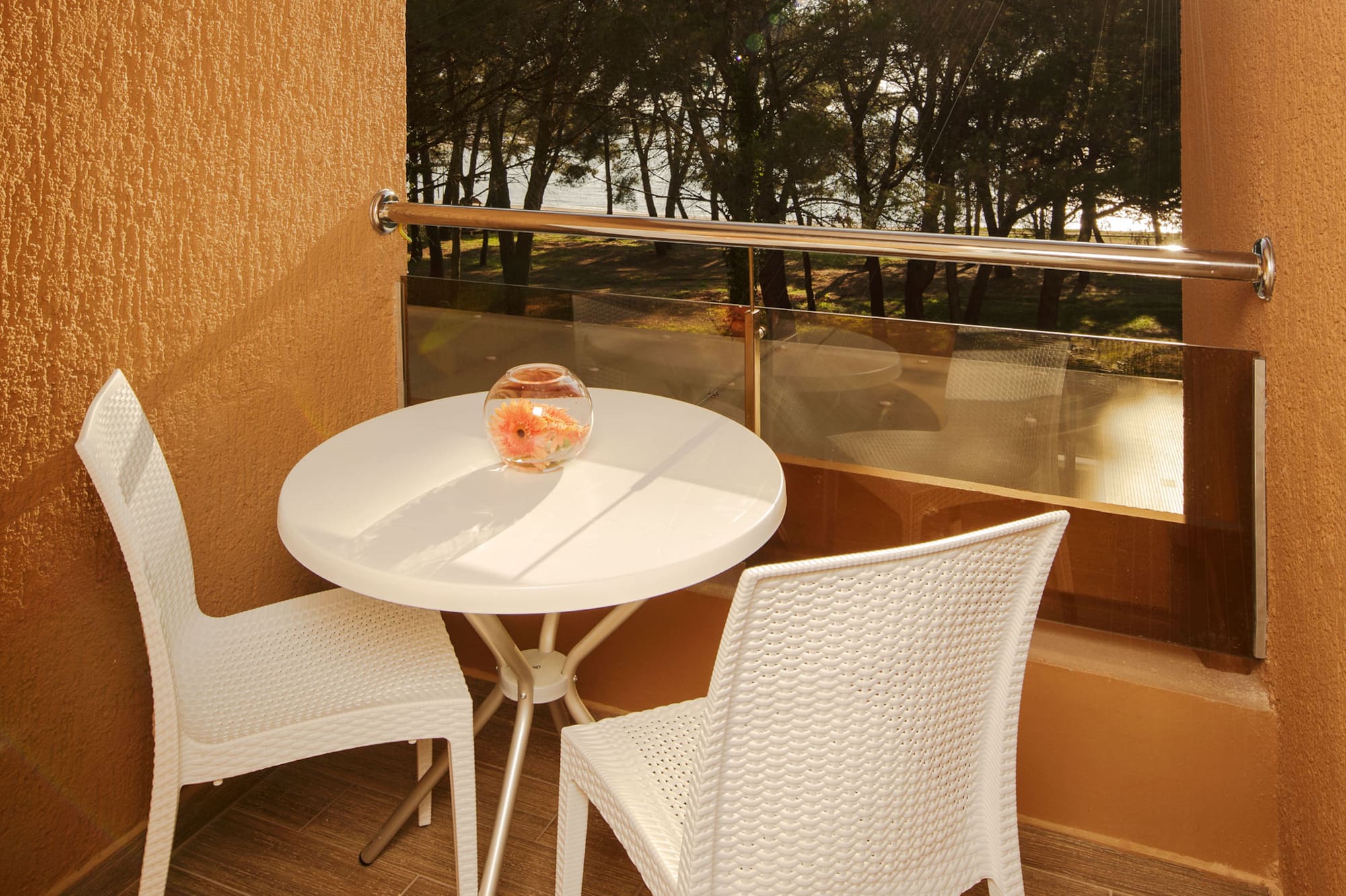 a table and chairs outside a window