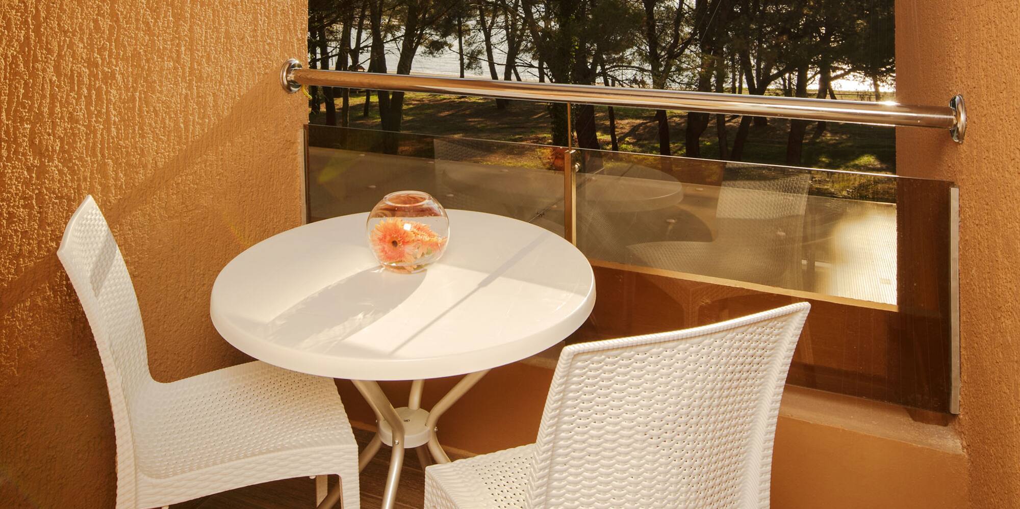 a table and chairs outside a window