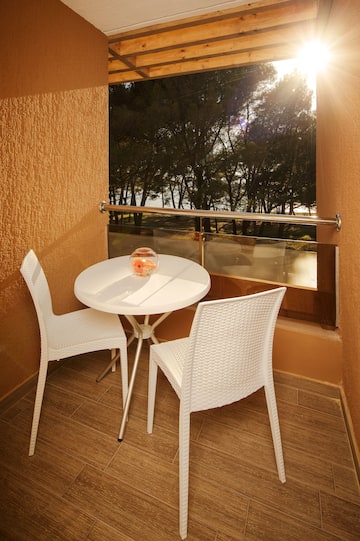 a table and chairs outside a window