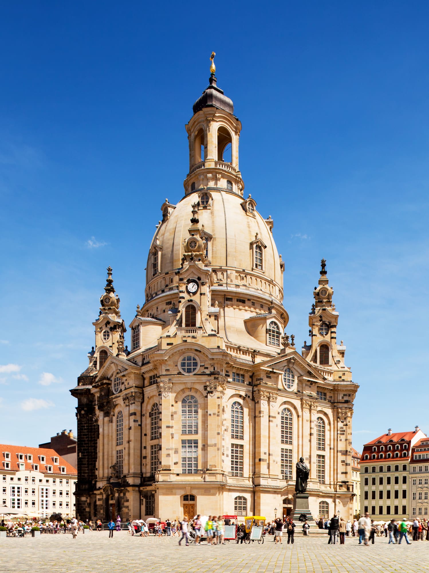 a large building with a dome and people in front with Dresden Frauenkirche in the background