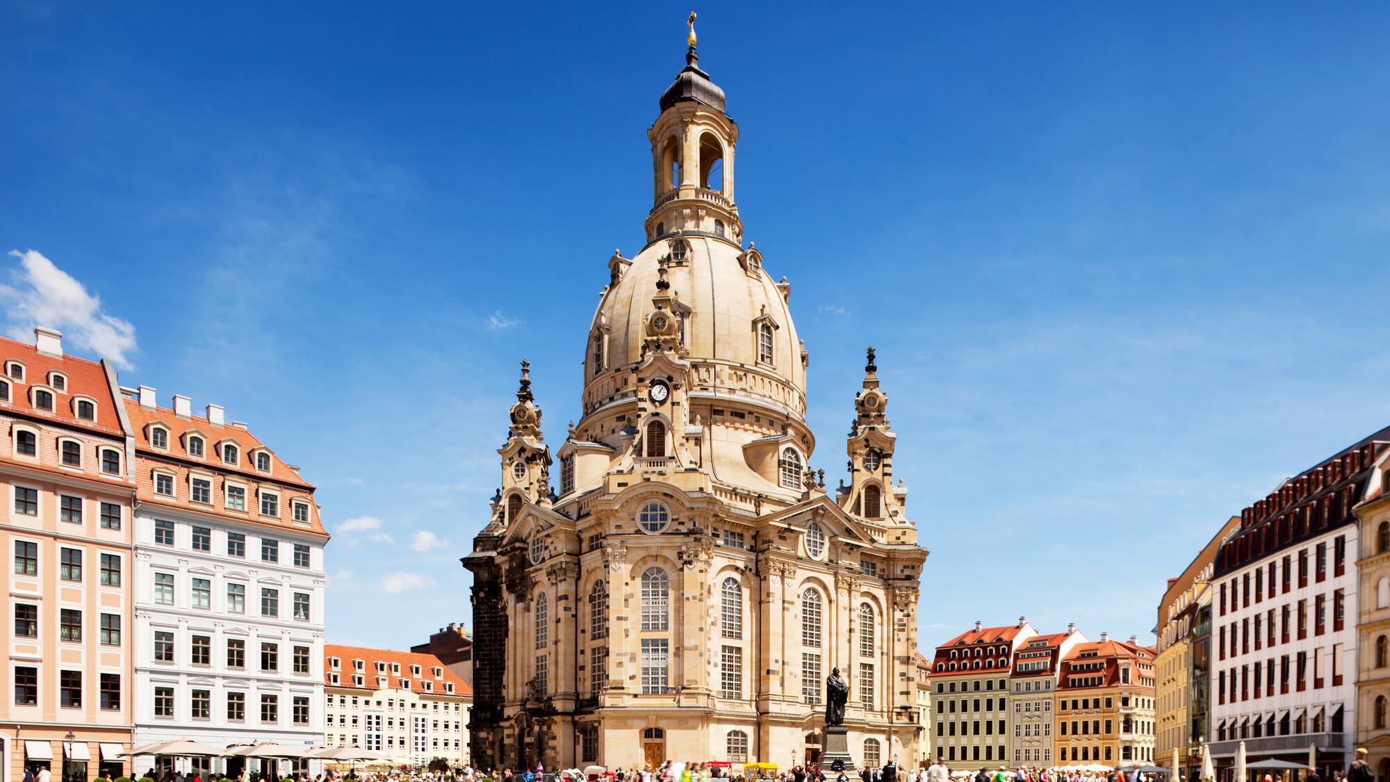 a large building with a dome and people in front with Dresden Frauenkirche in the background