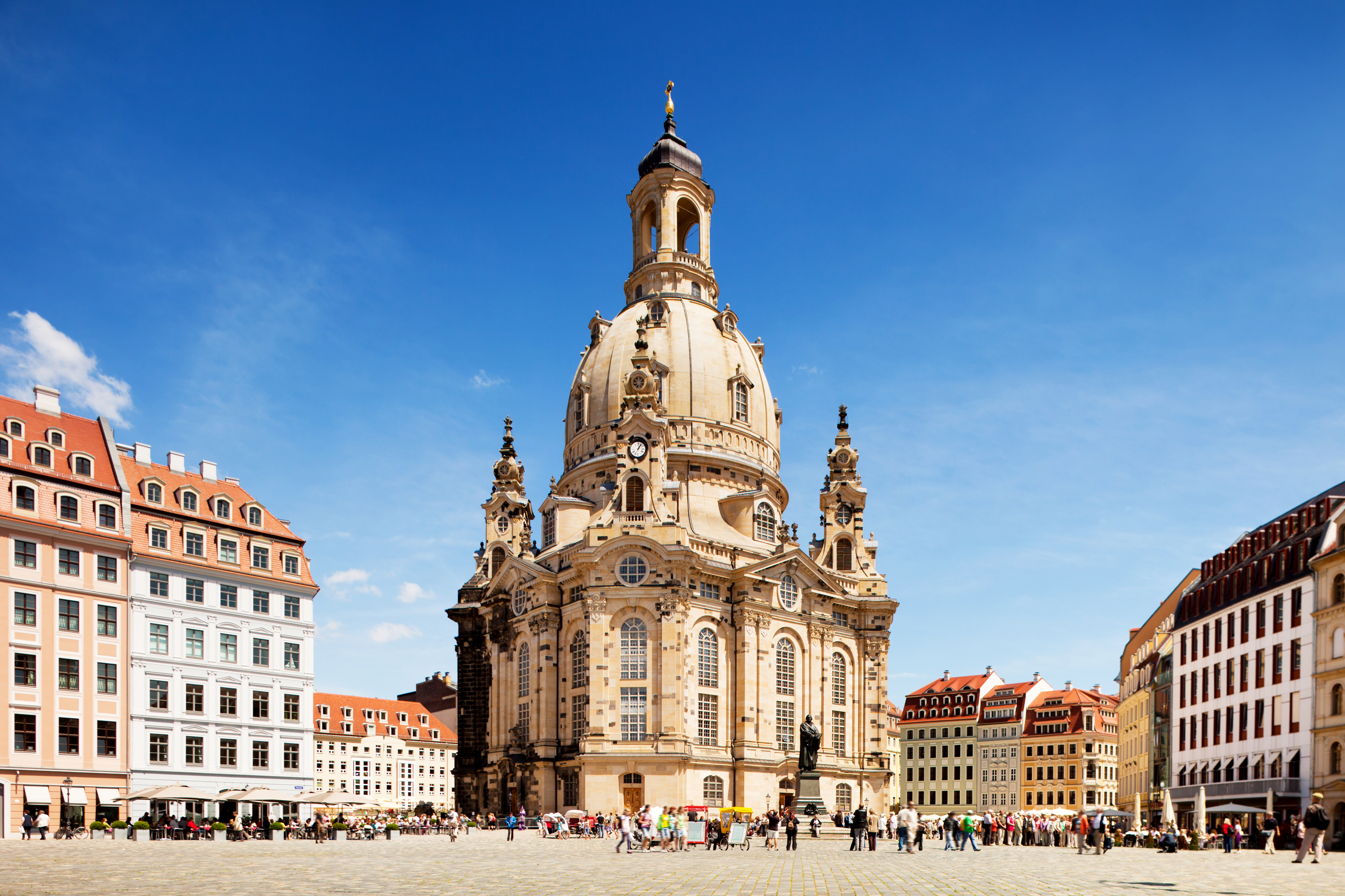 a large building with a dome and people in front with Dresden Frauenkirche in the background