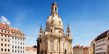a large building with a dome and people in front with Dresden Frauenkirche in the background
