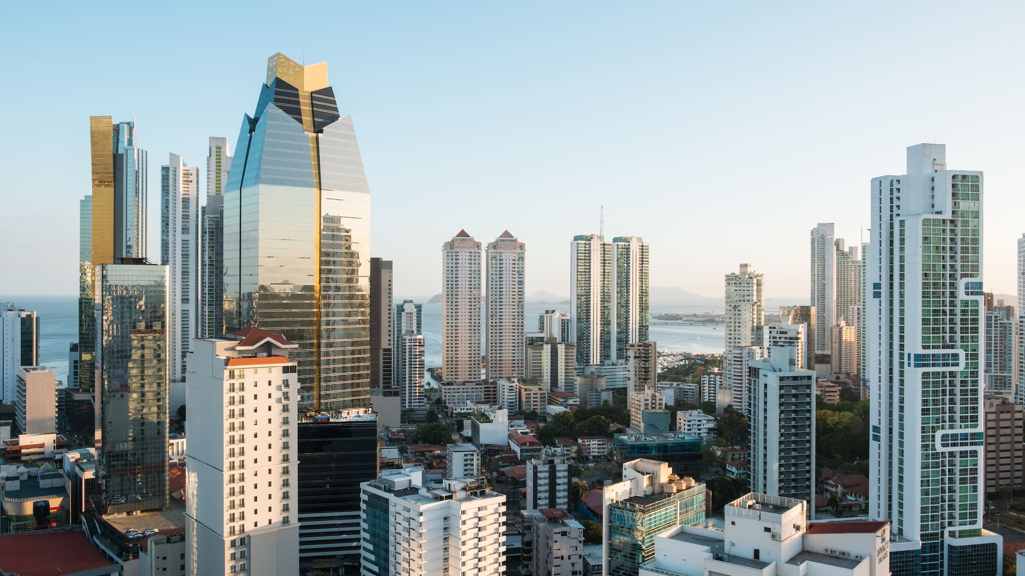 a city with tall buildings and water in the background