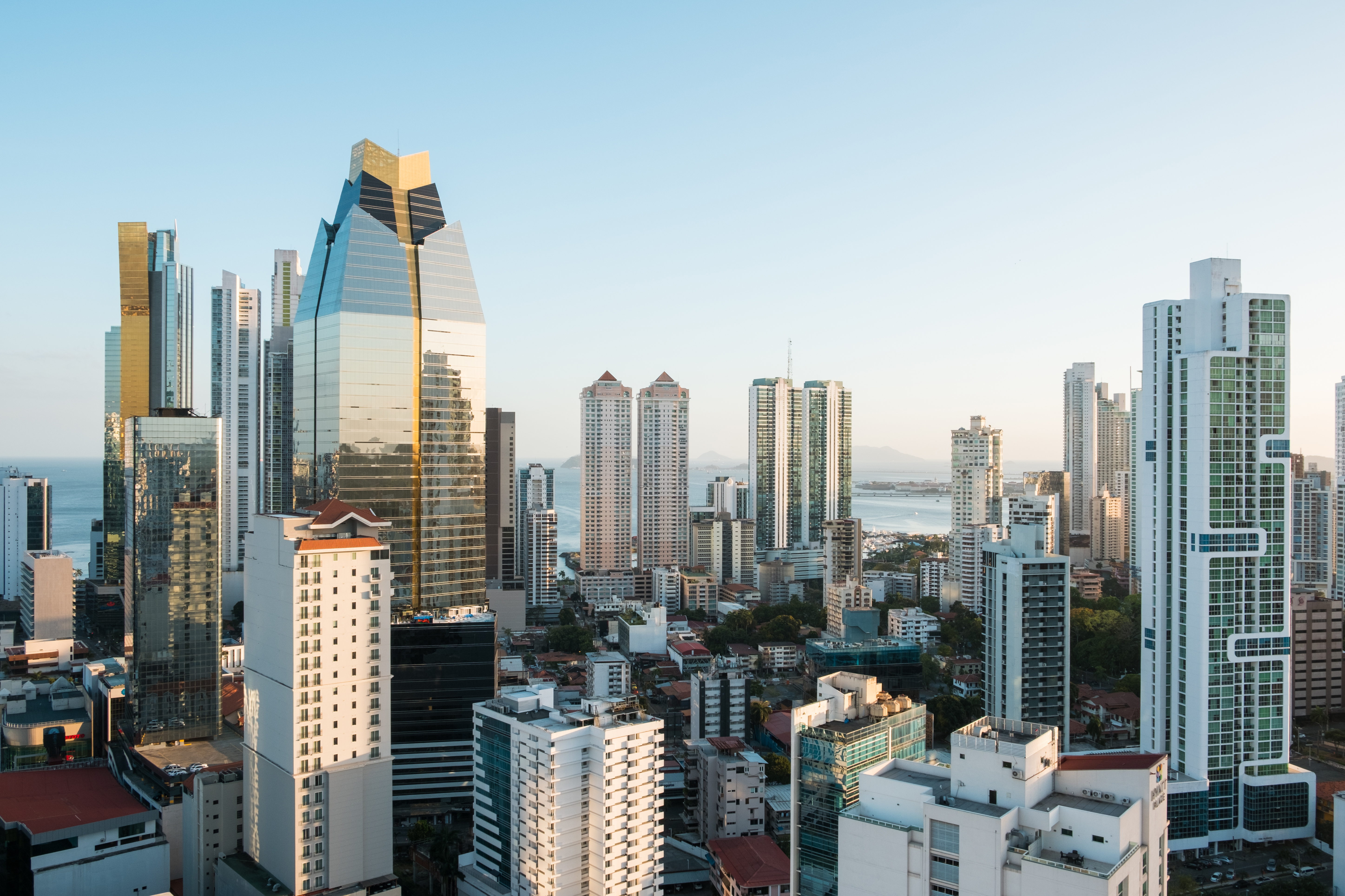 a city with tall buildings and water in the background
