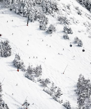 a group of people skiing on a snowy mountain