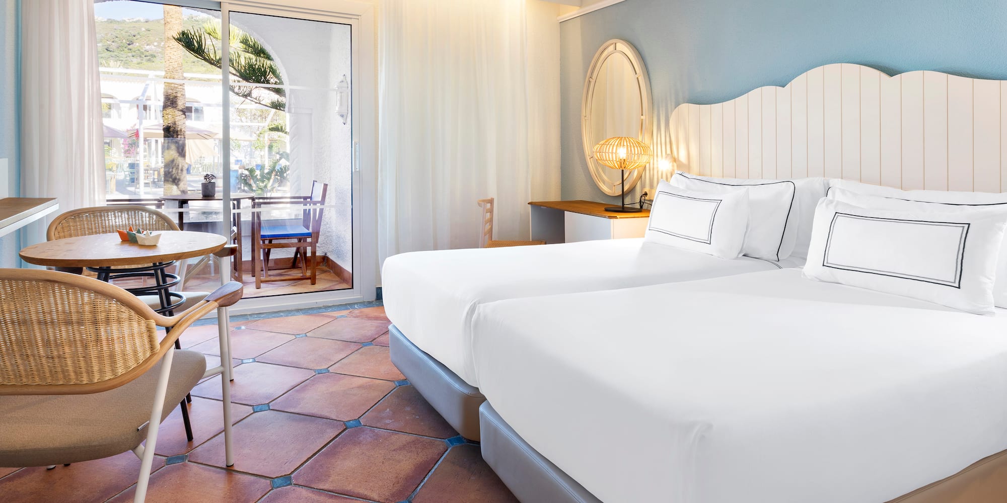 a room with two beds and a table