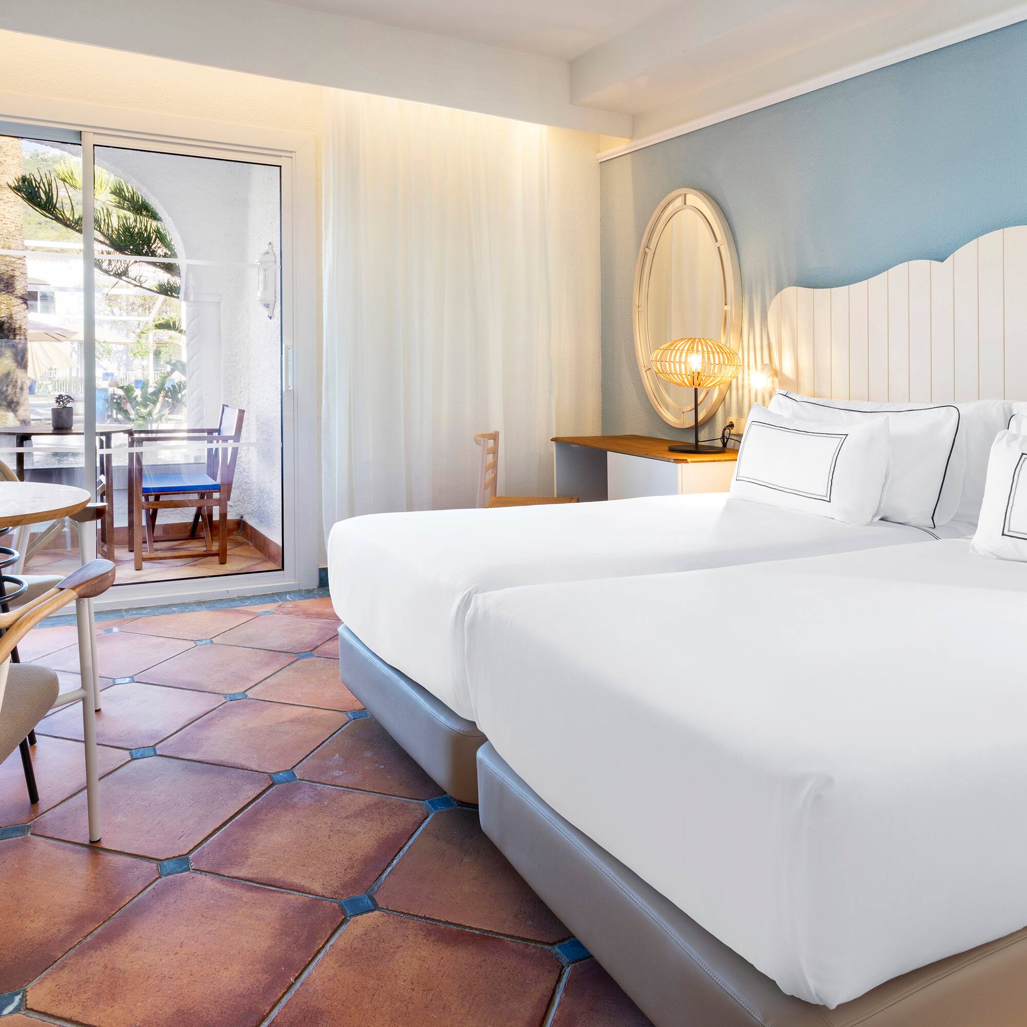 a room with two beds and a table