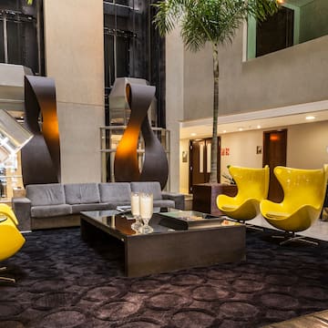 a room with a couch and yellow chairs