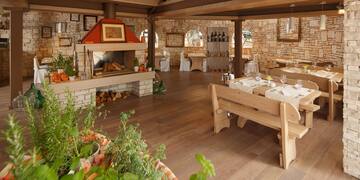 a room with a table and chairs and a fireplace