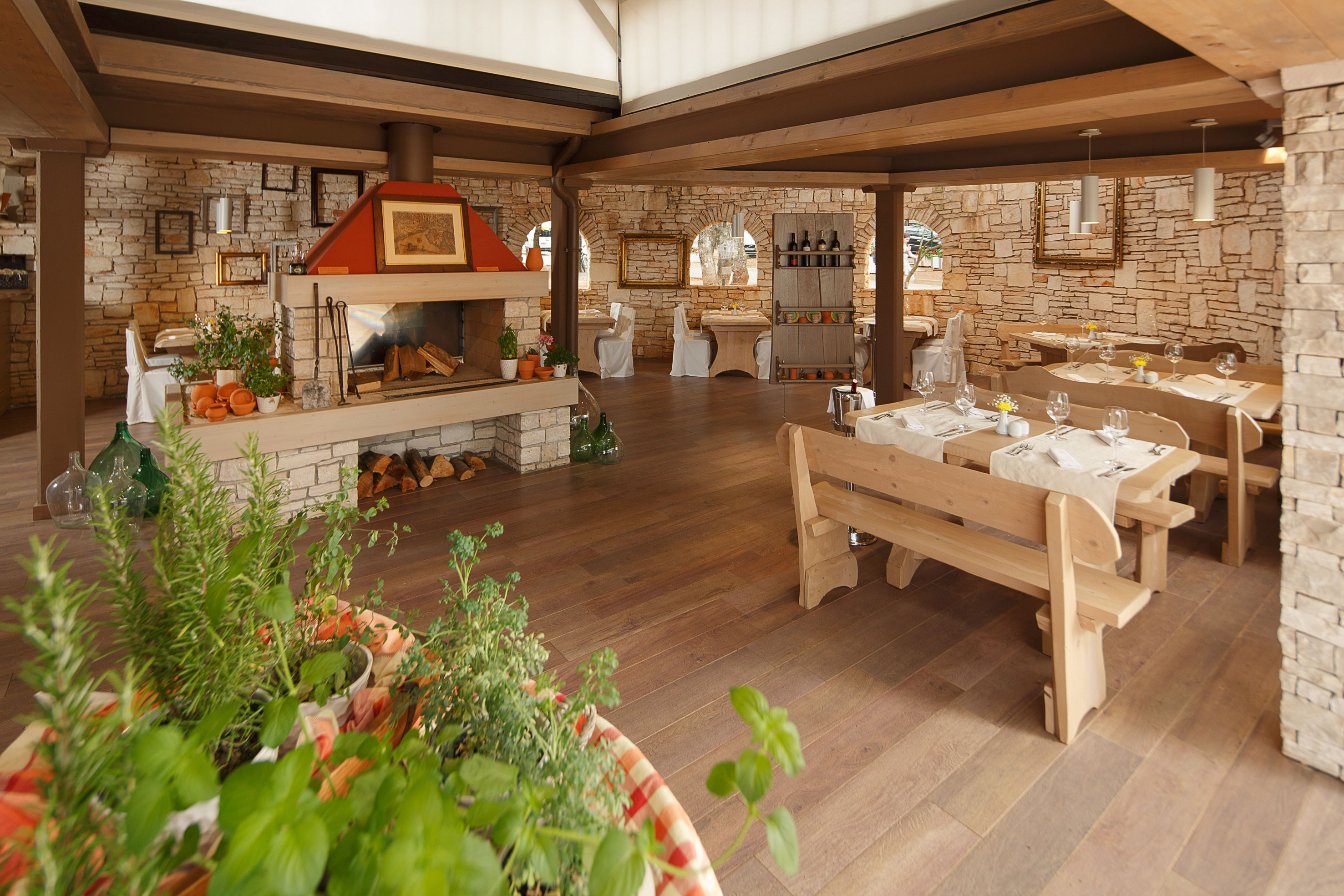 a room with a table and chairs and a fireplace