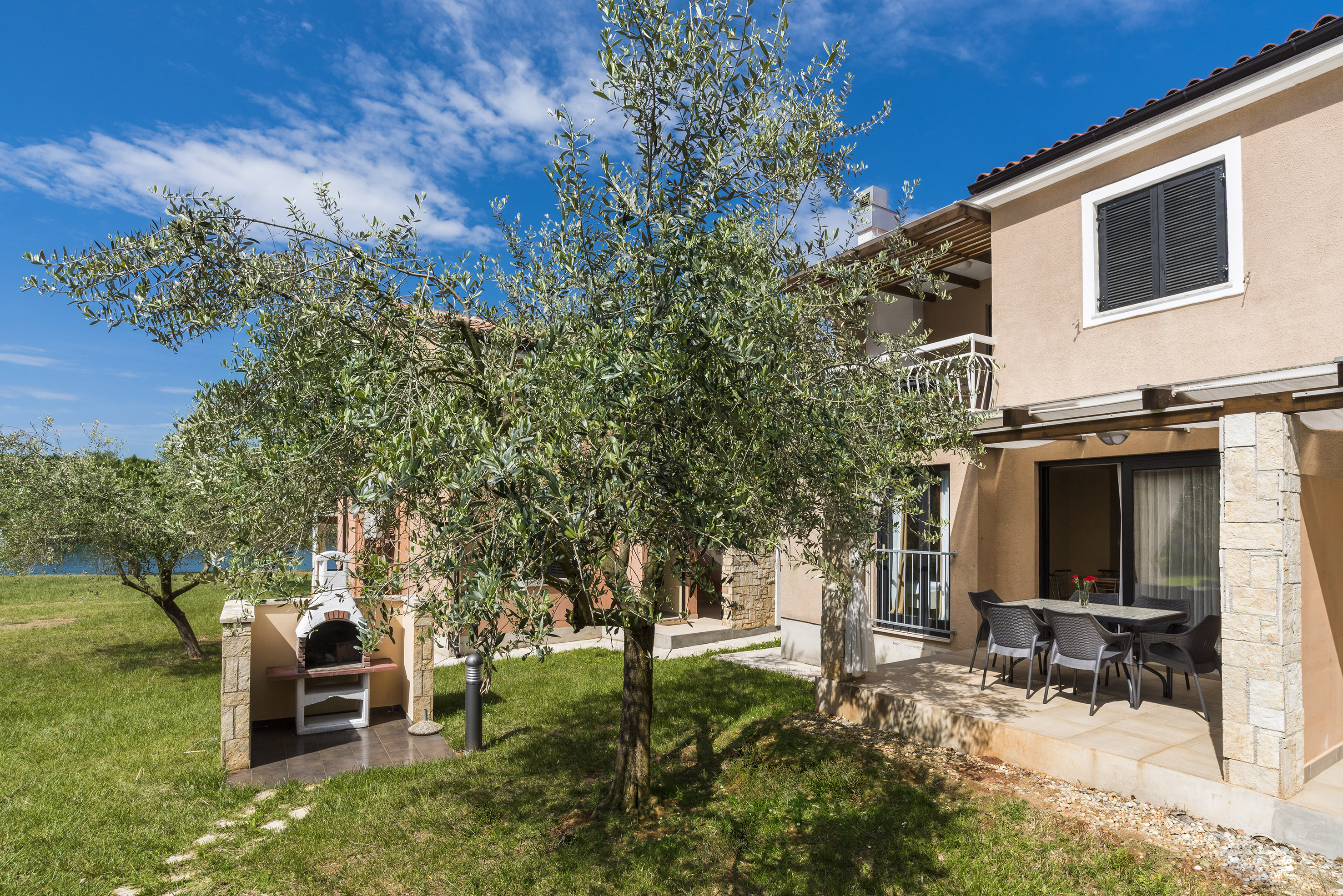 a tree in front of a house