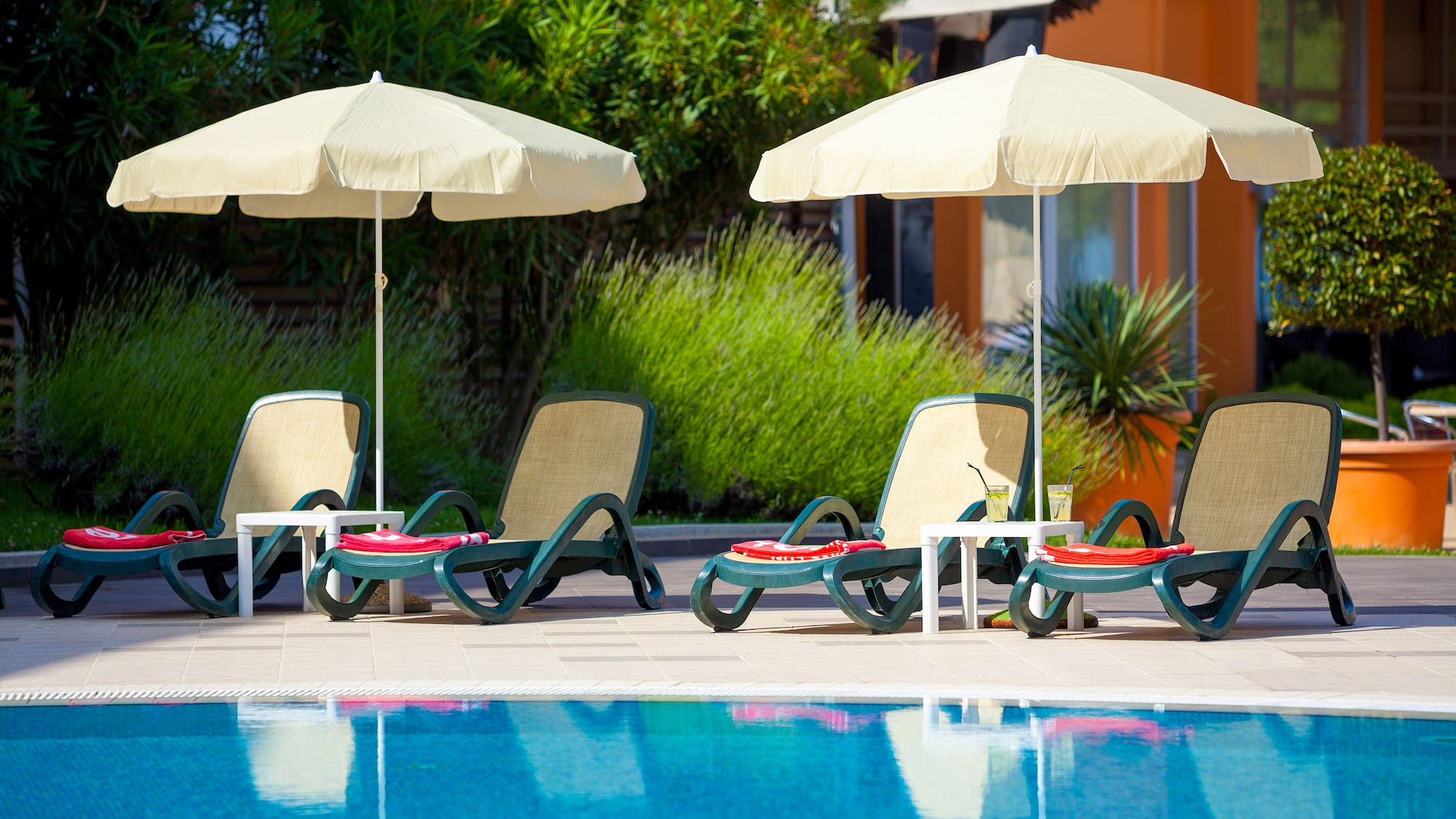 a pool with chairs and umbrellas