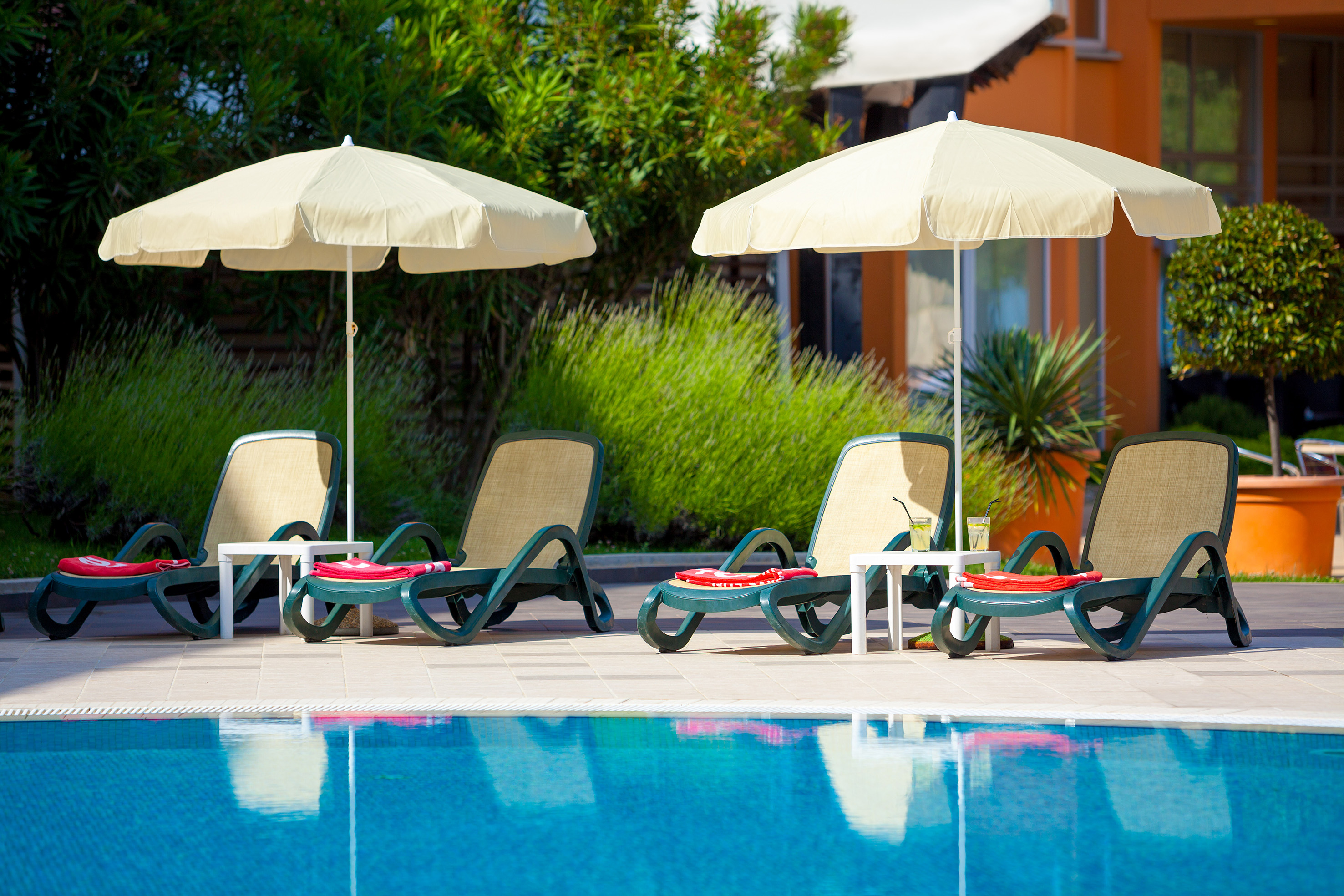 a pool with chairs and umbrellas