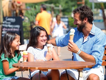 a man and two girls eating ice cream