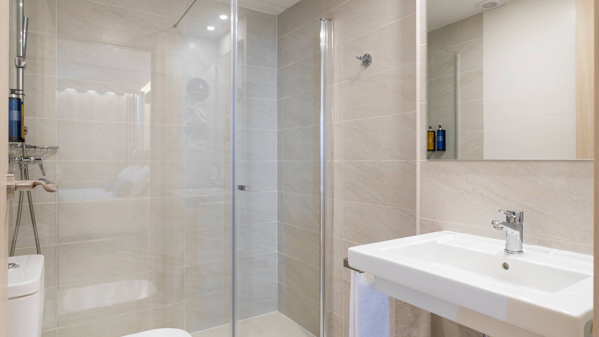a bathroom with a glass shower and sink