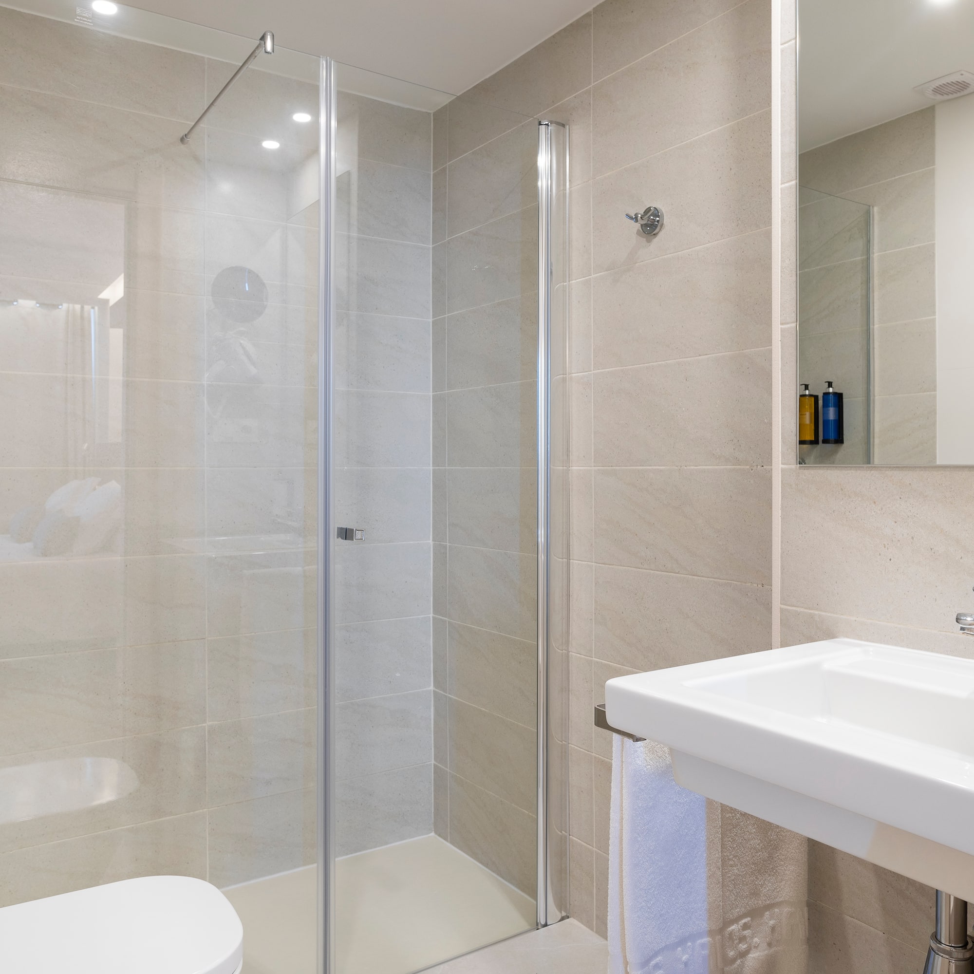a bathroom with a glass shower and sink