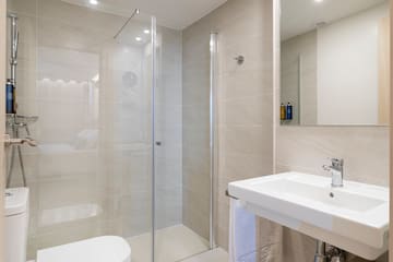 a bathroom with a glass shower and sink