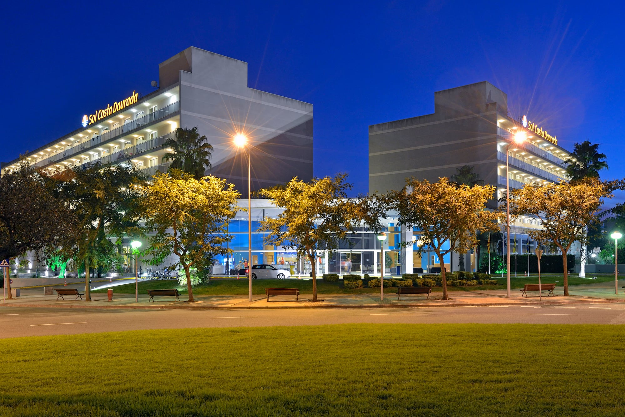 a building with trees and a lawn