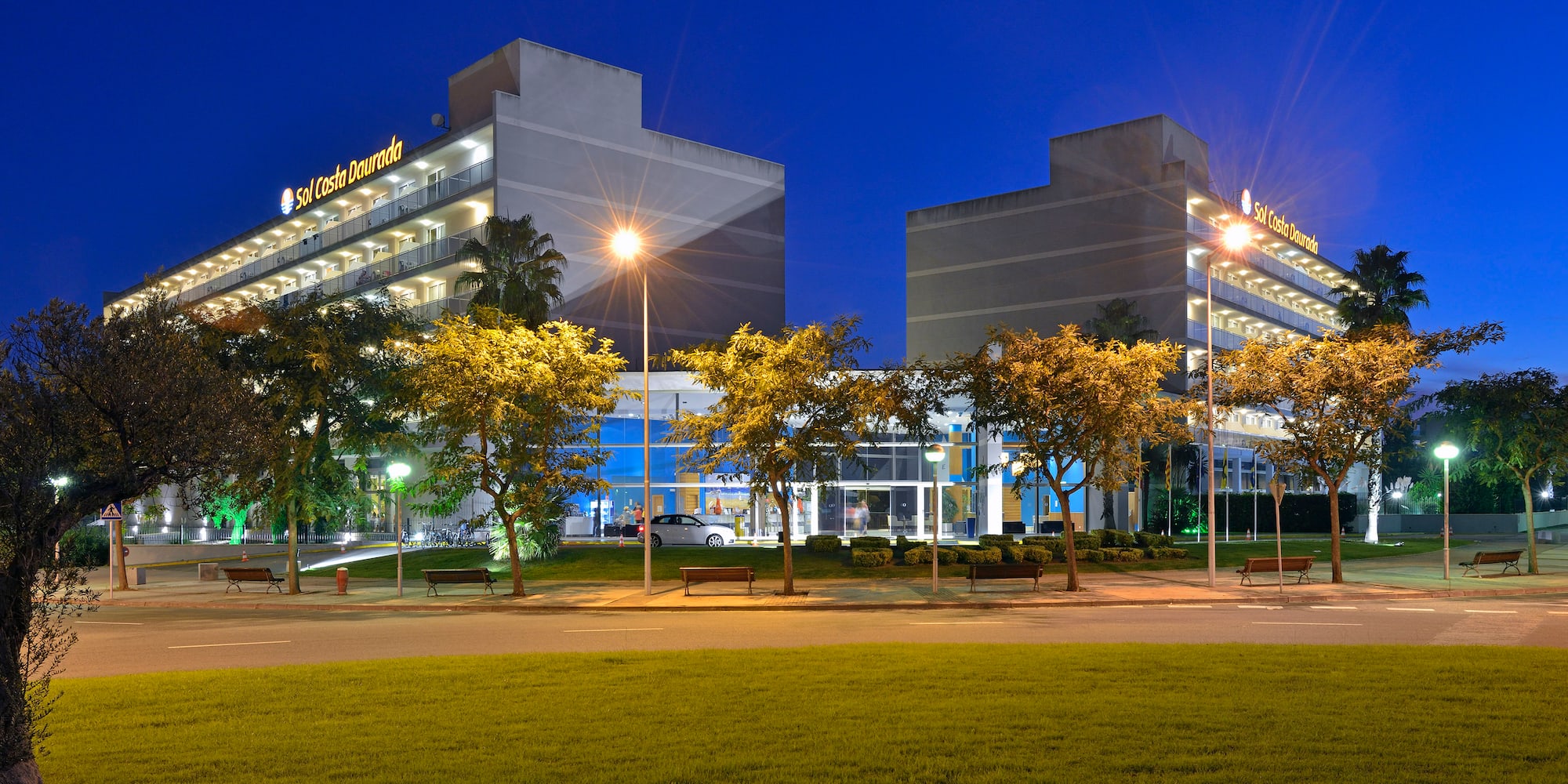 a building with trees and a lawn
