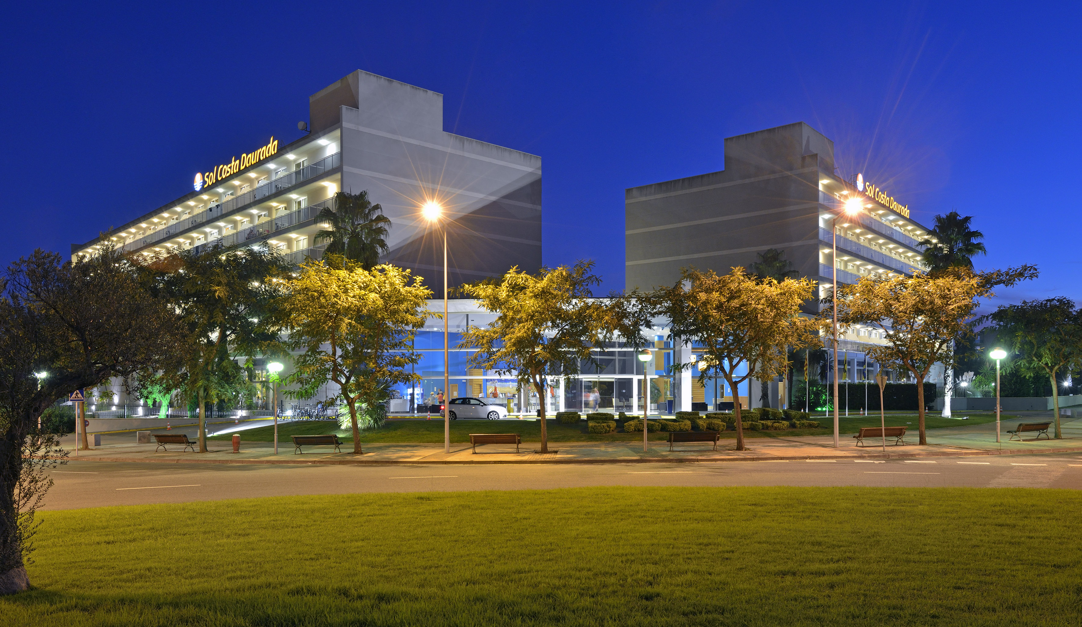 a building with trees and a lawn
