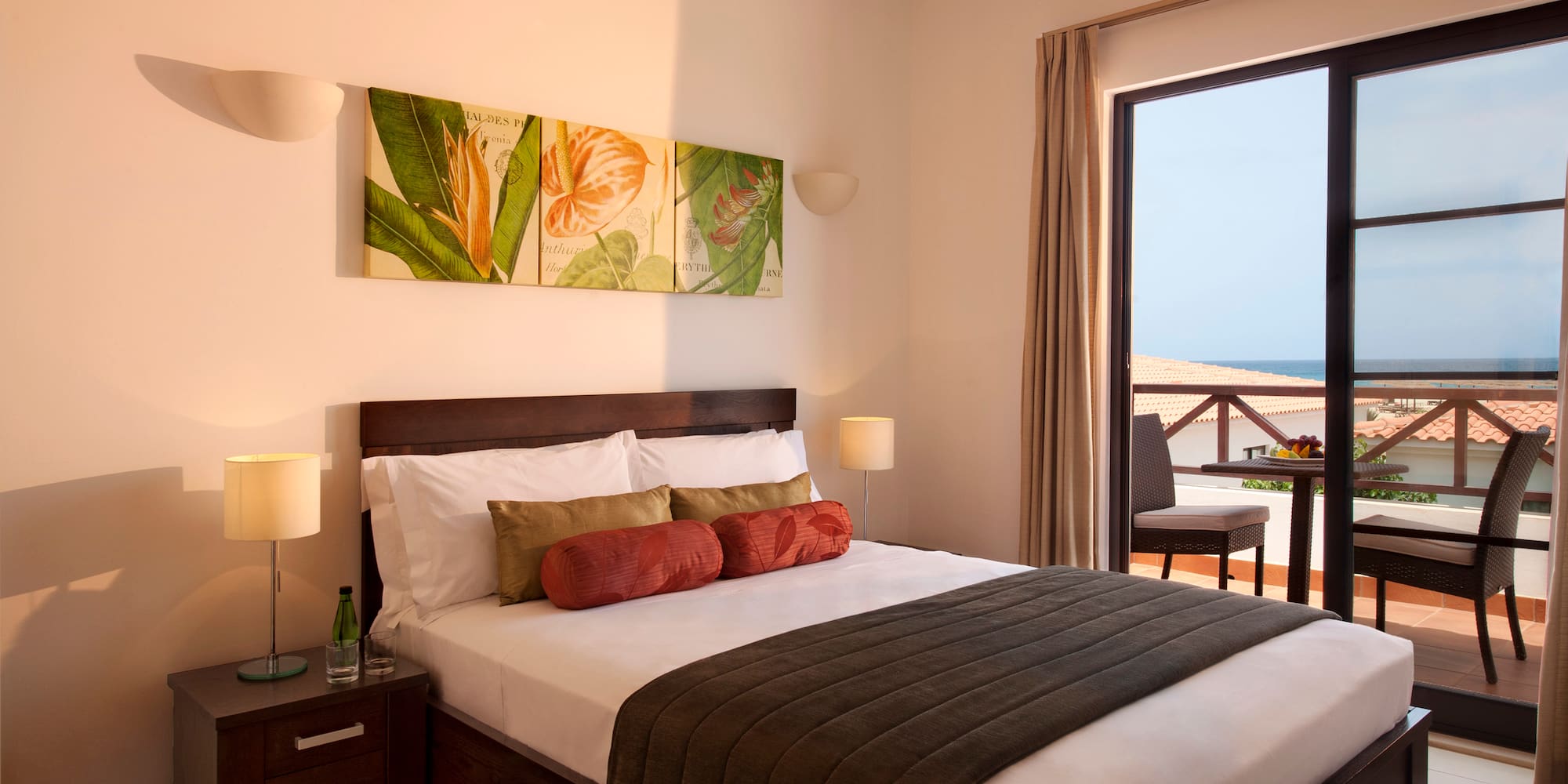 a bedroom with a large window and a bed