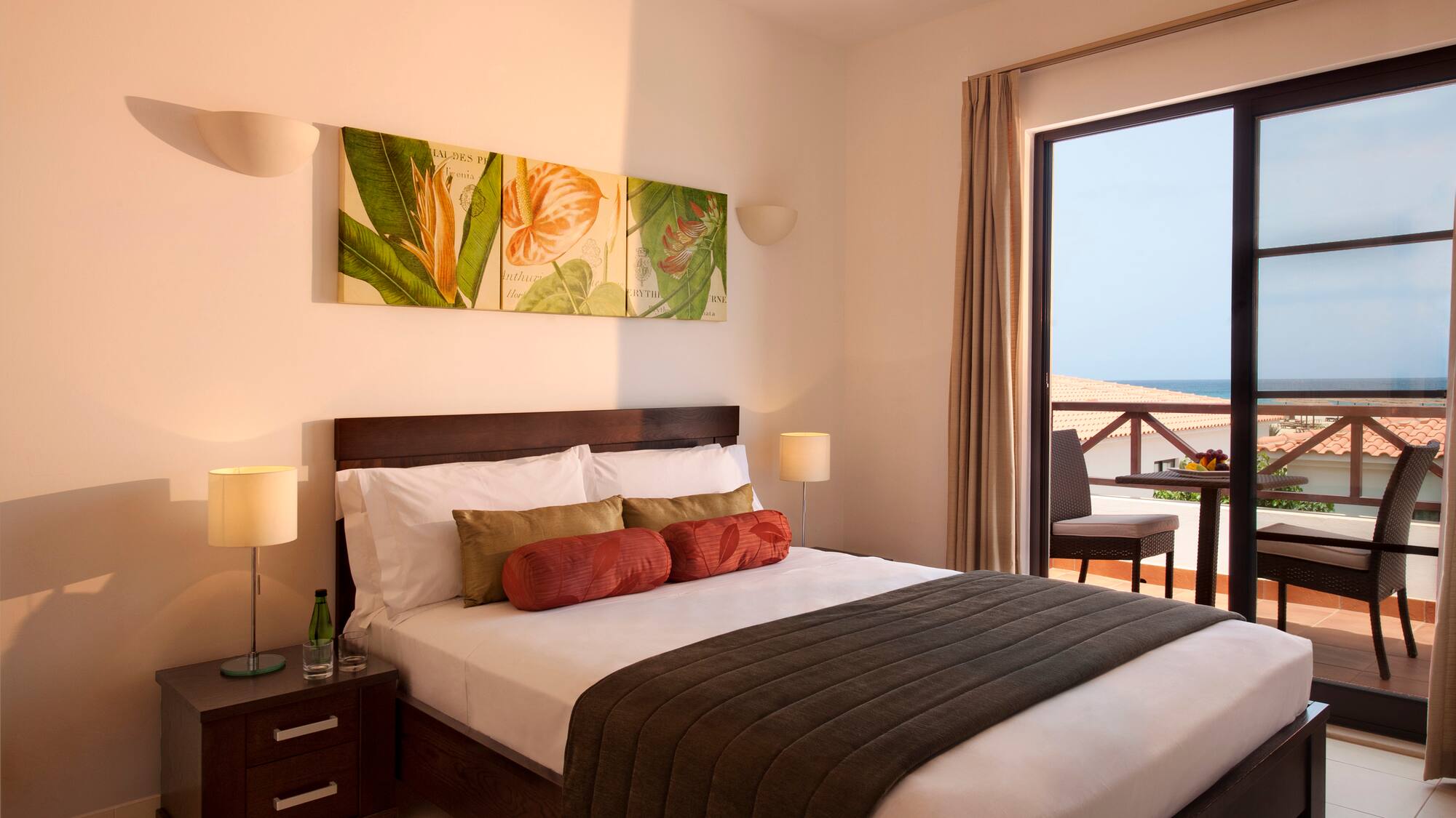 a bedroom with a large window and a bed