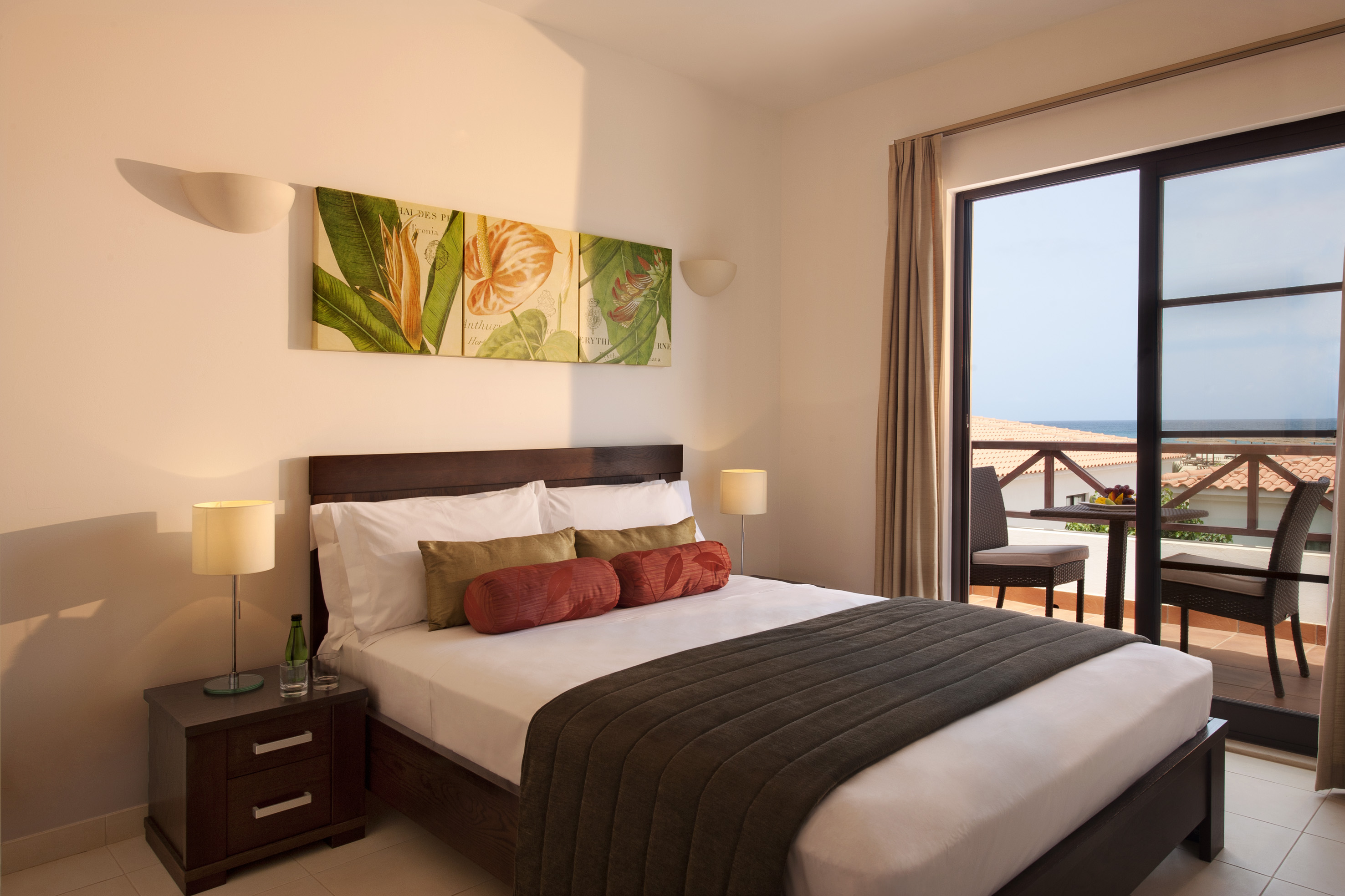 a bedroom with a large window and a bed