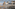 Reichstag building, modern parliament buildings, Spree River, and boat in Berlin.
