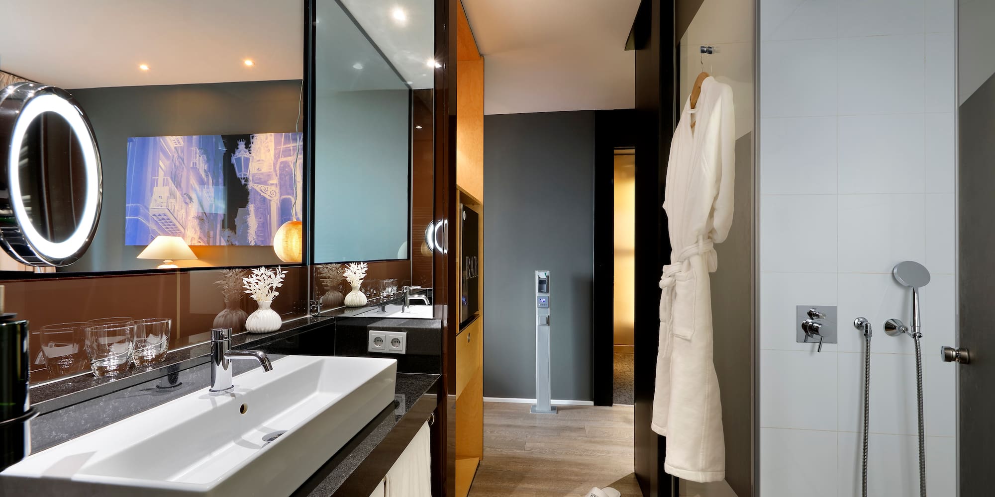 a bathroom with a white bathrobe and a mirror