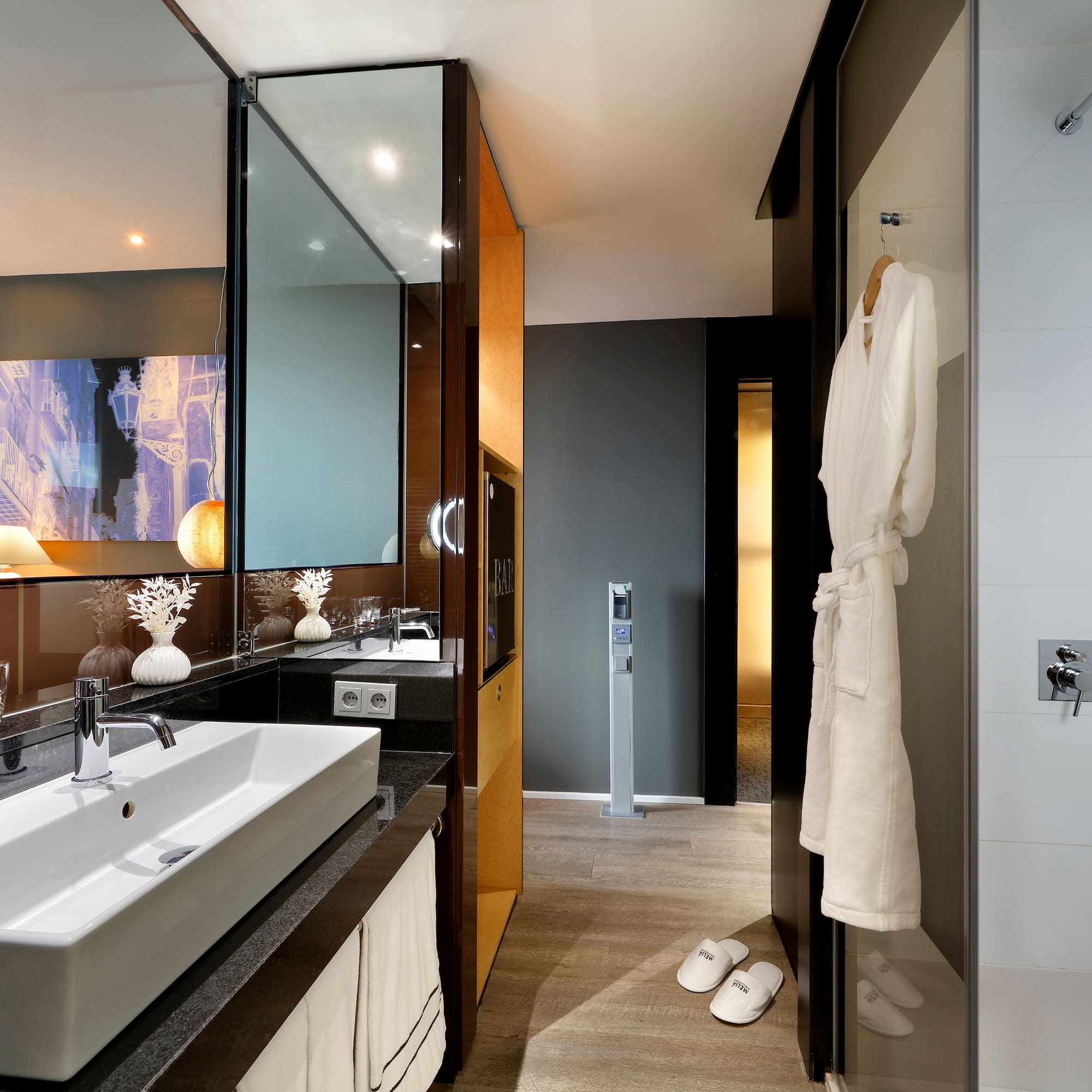a bathroom with a white bathrobe and a mirror